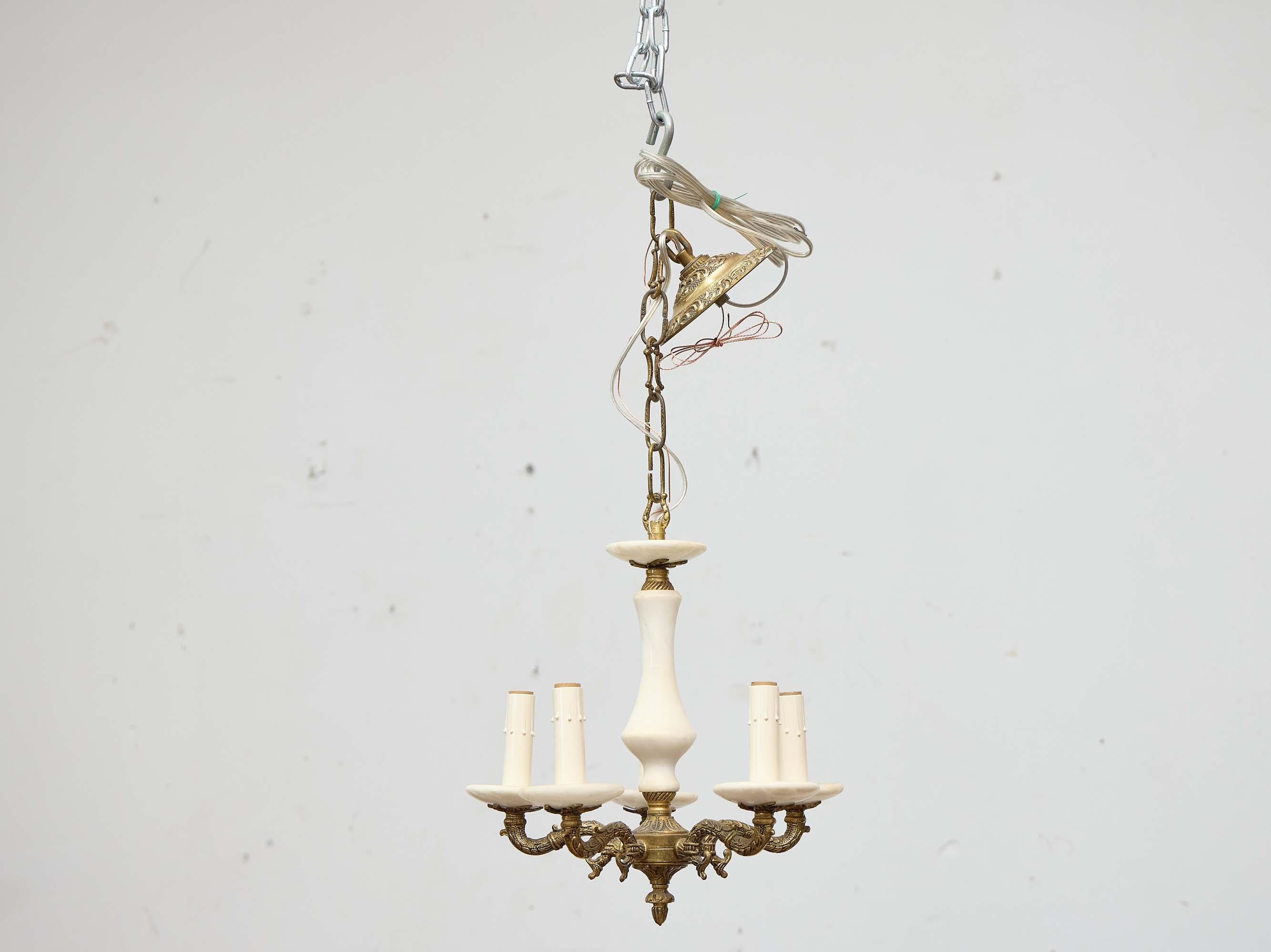 Un raffinato lampadario italiano del Medioevo che abbina l'alabastro liscio al bronzo dorato finemente fuso. La composizione è incentrata su un gambo in alabastro tornito in una calda tonalità avorio, accentuato nella parte superiore e alla base da