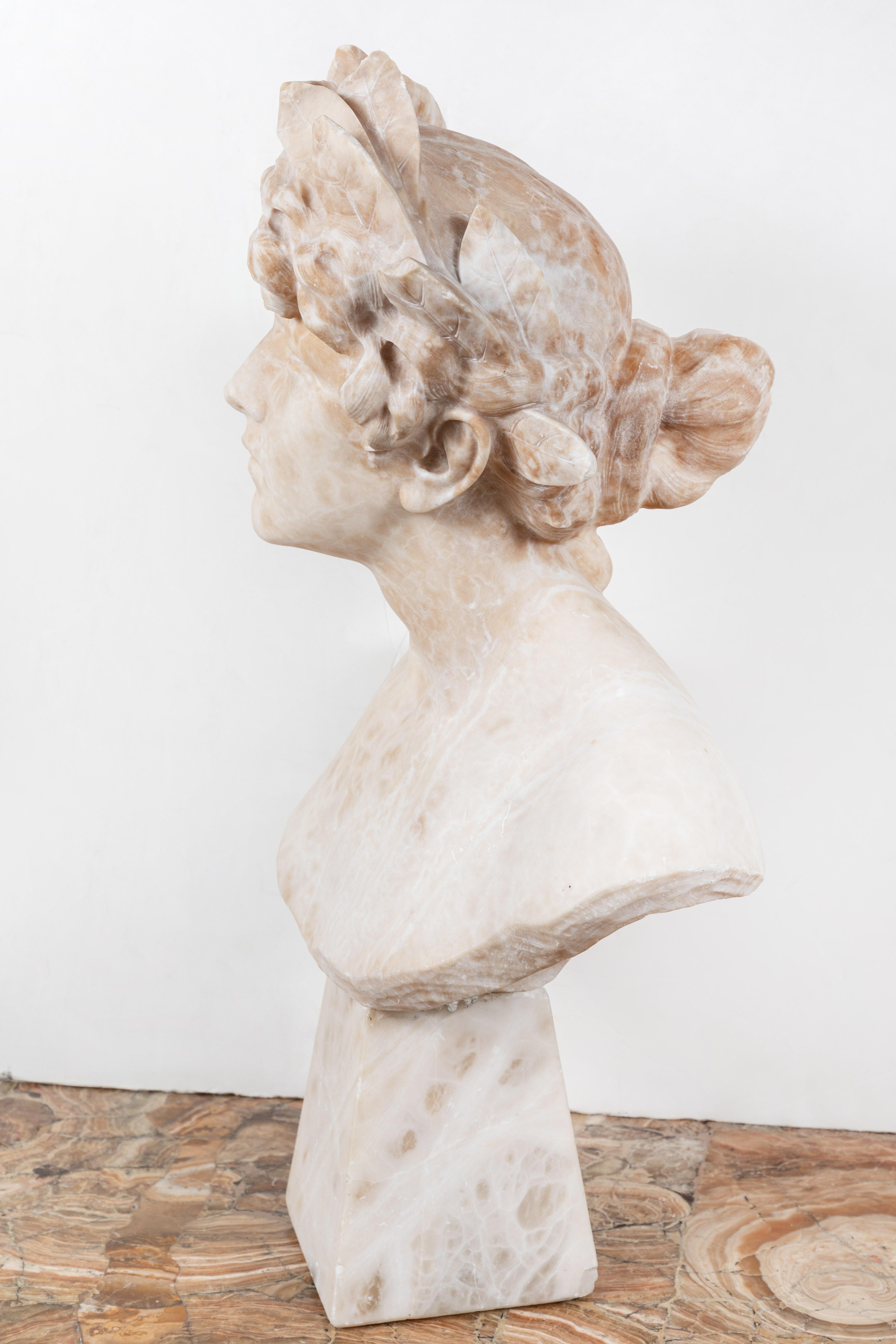 Beautifully carved, mounted, Liberty Period alabaster bust- an allegory of victory. The female figure featuring an elegant gaze. Her richly curled and bound hair is surmounted by a thick crown of laurels.