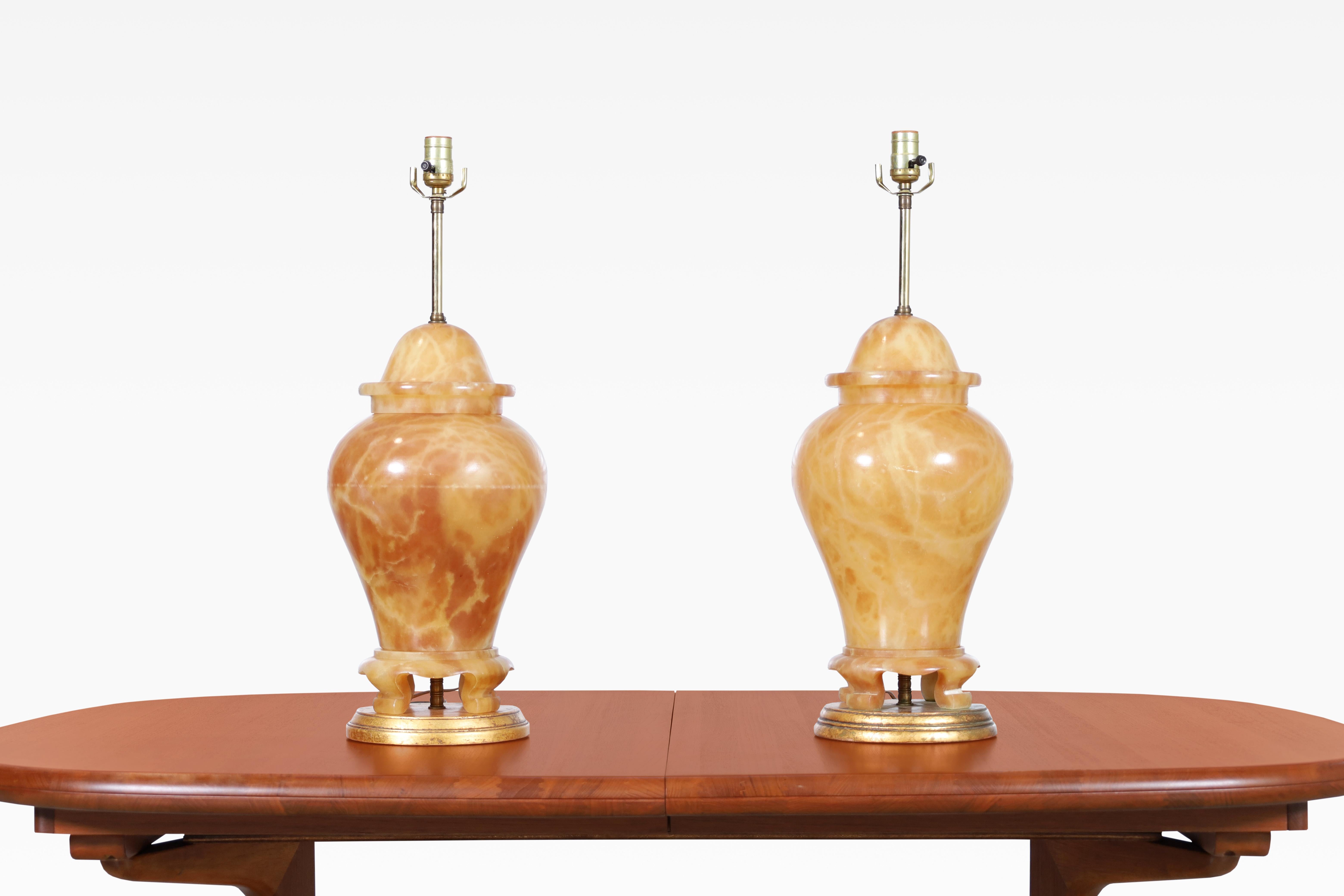 Beautiful Italian alabaster ginger jar table lamps, designed in Italy, circa 1960’s. These lamps are truly elegant, featuring a polished alabaster finish that's topped off with beautiful brass hardware. What sets them apart from other lamps is their