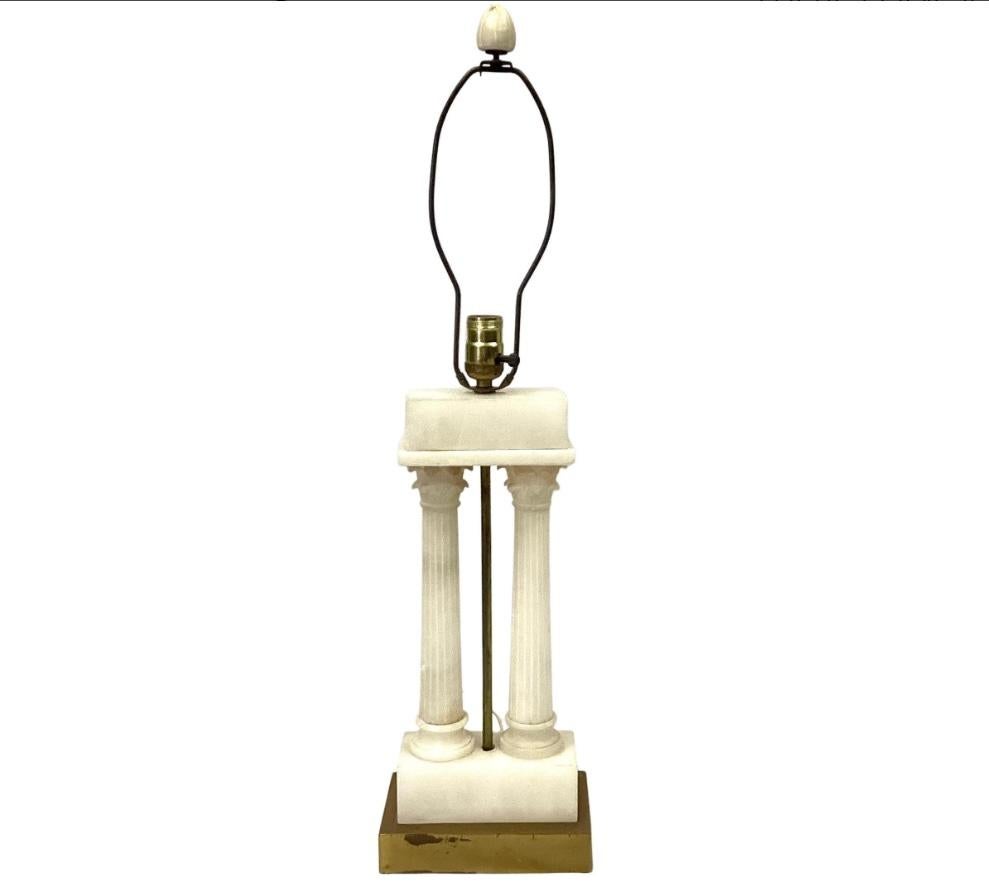 Early 20th century Italian Grand Tour alabaster lamp with two Roman columns. Lamp rests on gold square metal base. Original alabaster finial. In good working condition. 
