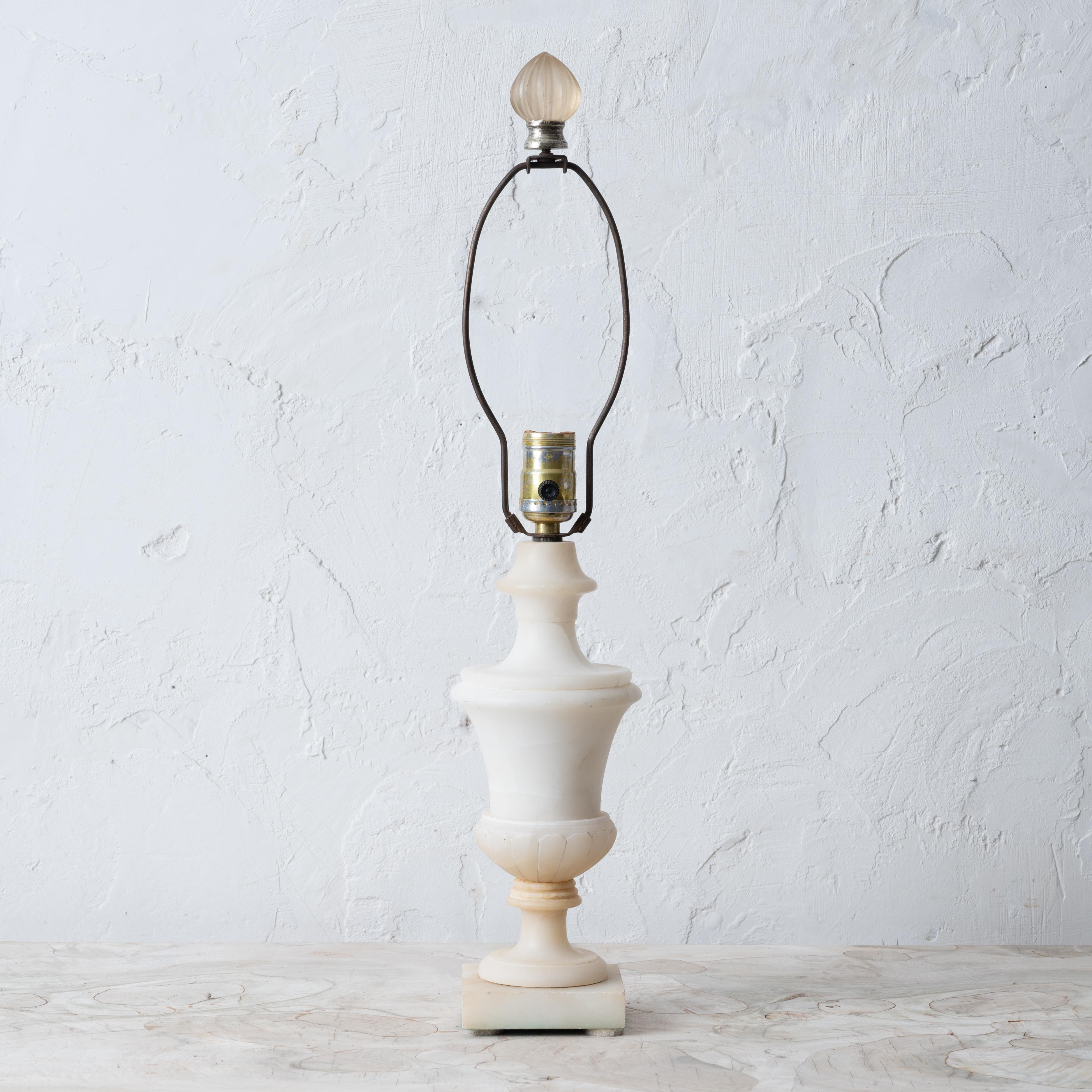 An Italian alabaster lamp, mid-20th Century.

4 ¾ by 23 ½ inches tall; 11 ¾ measured to top of alabaster

