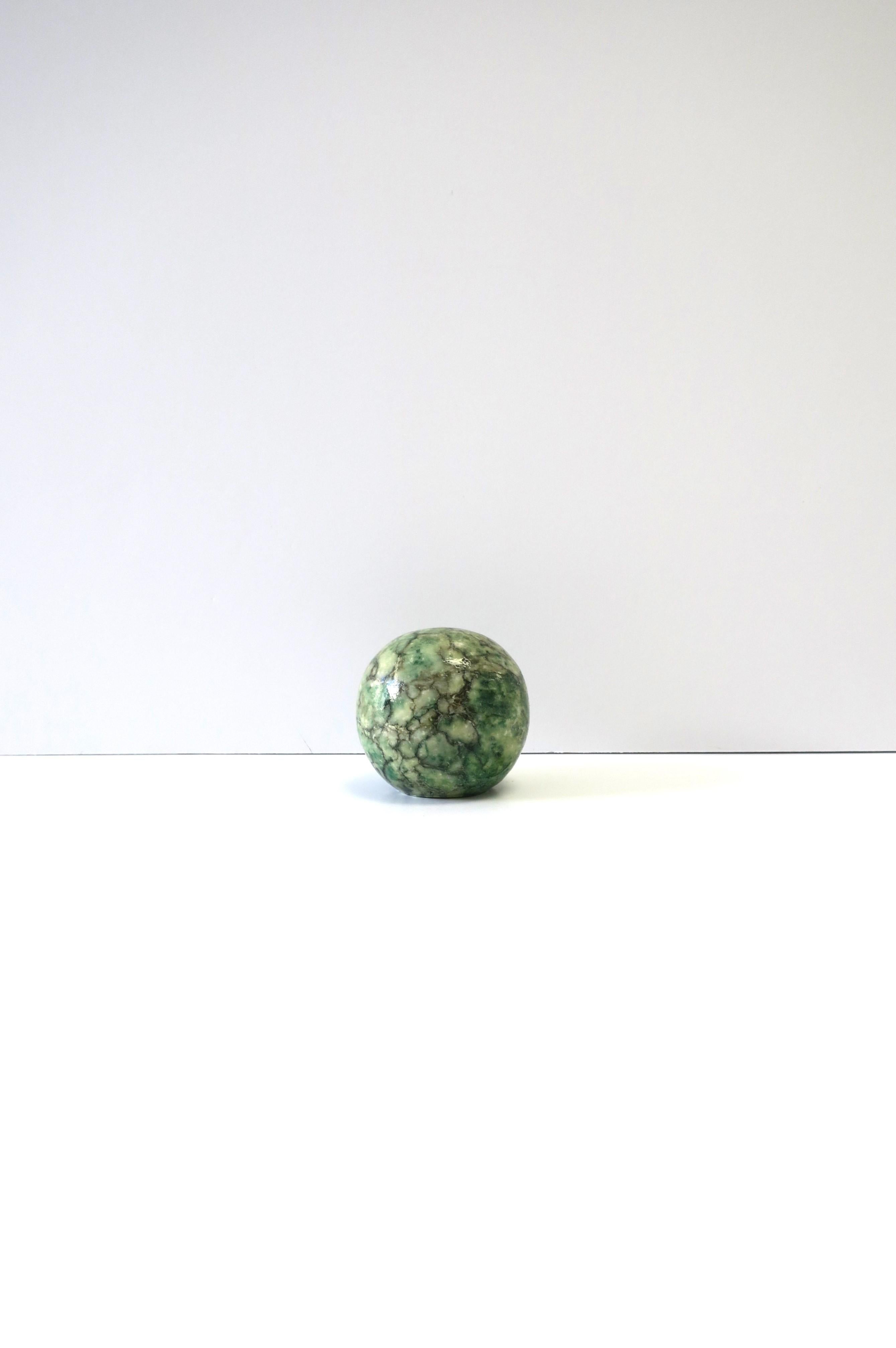 A small green, black and white alabaster marble decorative object sphere or paperweight, '70 Modern, circa 1970s, Italy. A great decorative object or paperweight for an office, desk, shelf, library, etc. Dimensions: 2.25