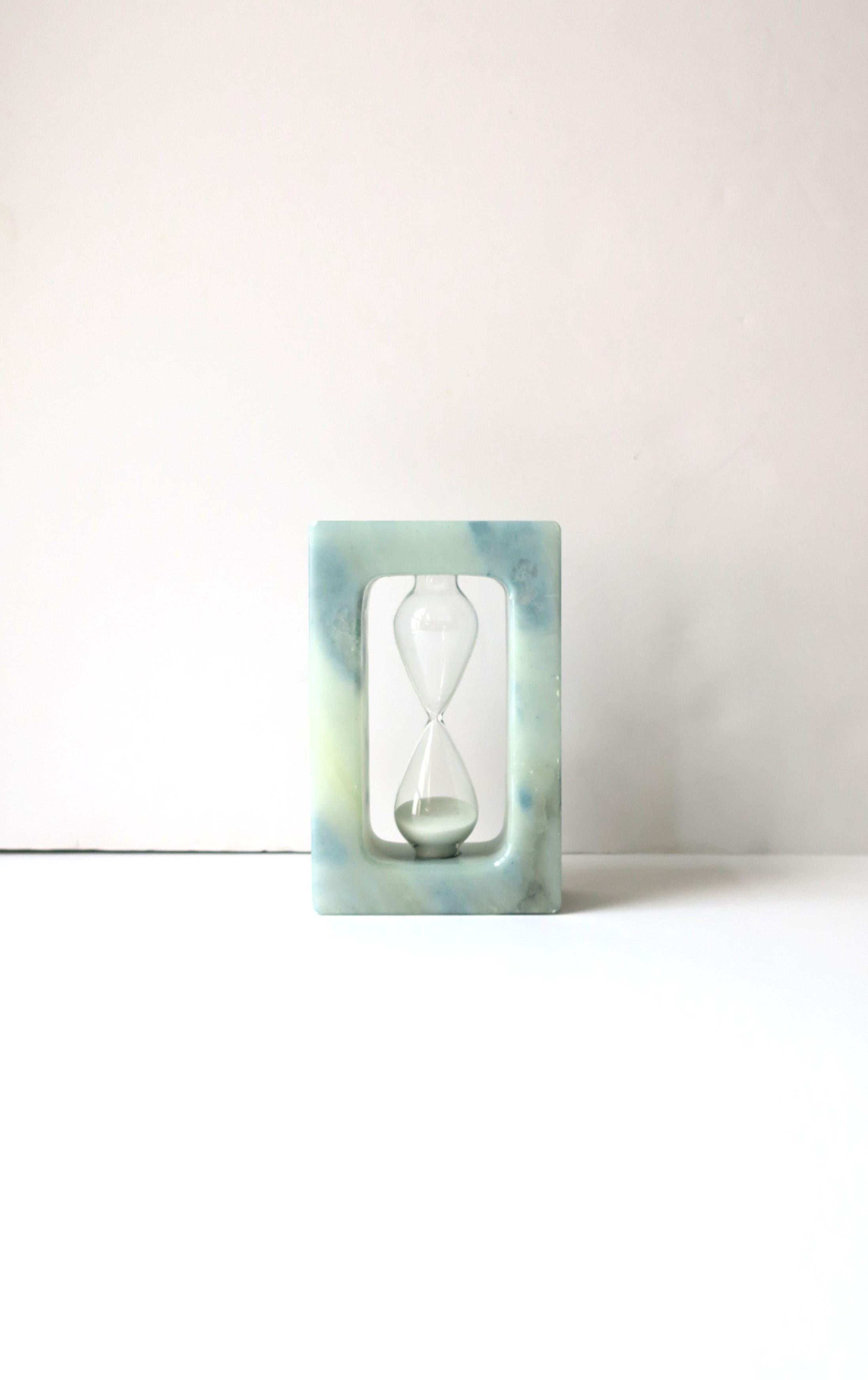 An Italian Modern Postmodern period light blue alabaster marble hourglass timer, circa late-20th century, Italy. A great decorative object or kitchen item. 