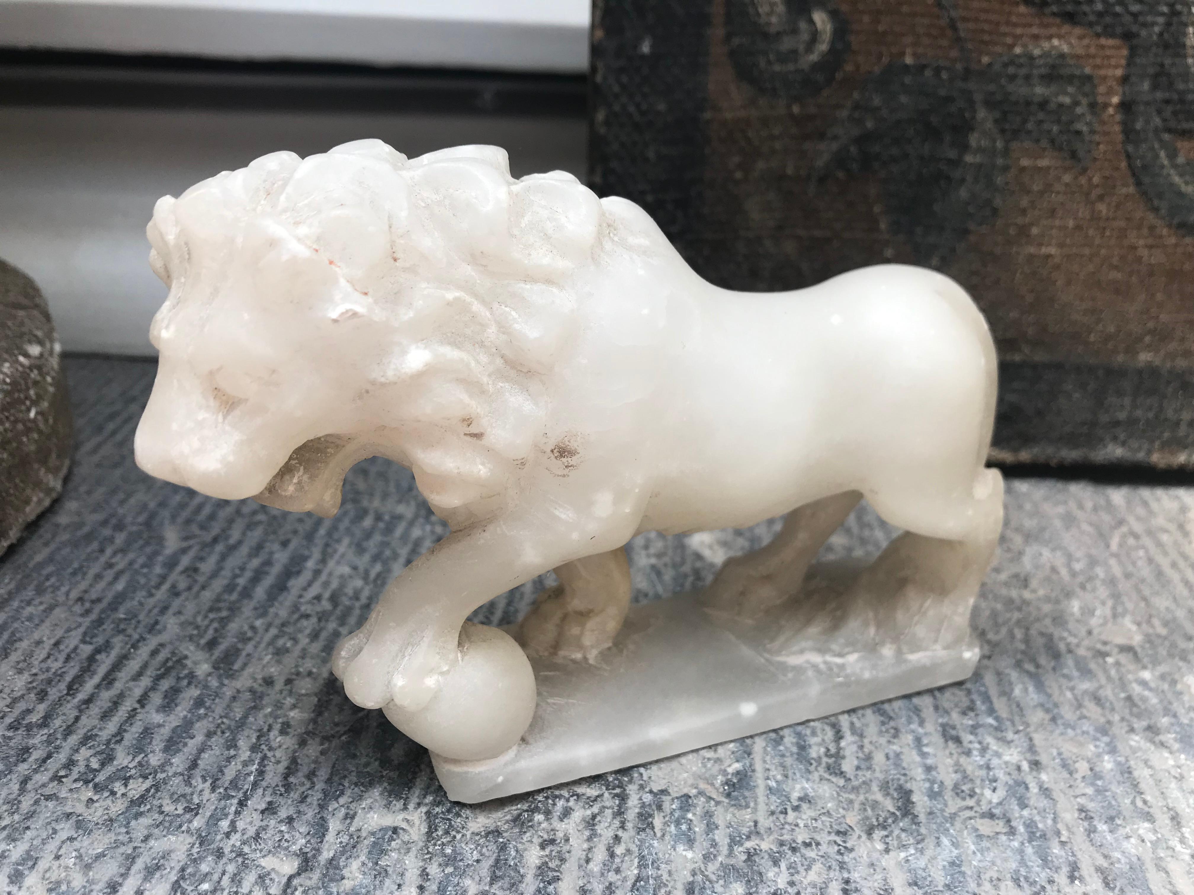 Hand carved Italian alabaster stone statue of a lion, circa 1940. A miniature version of the Italian 