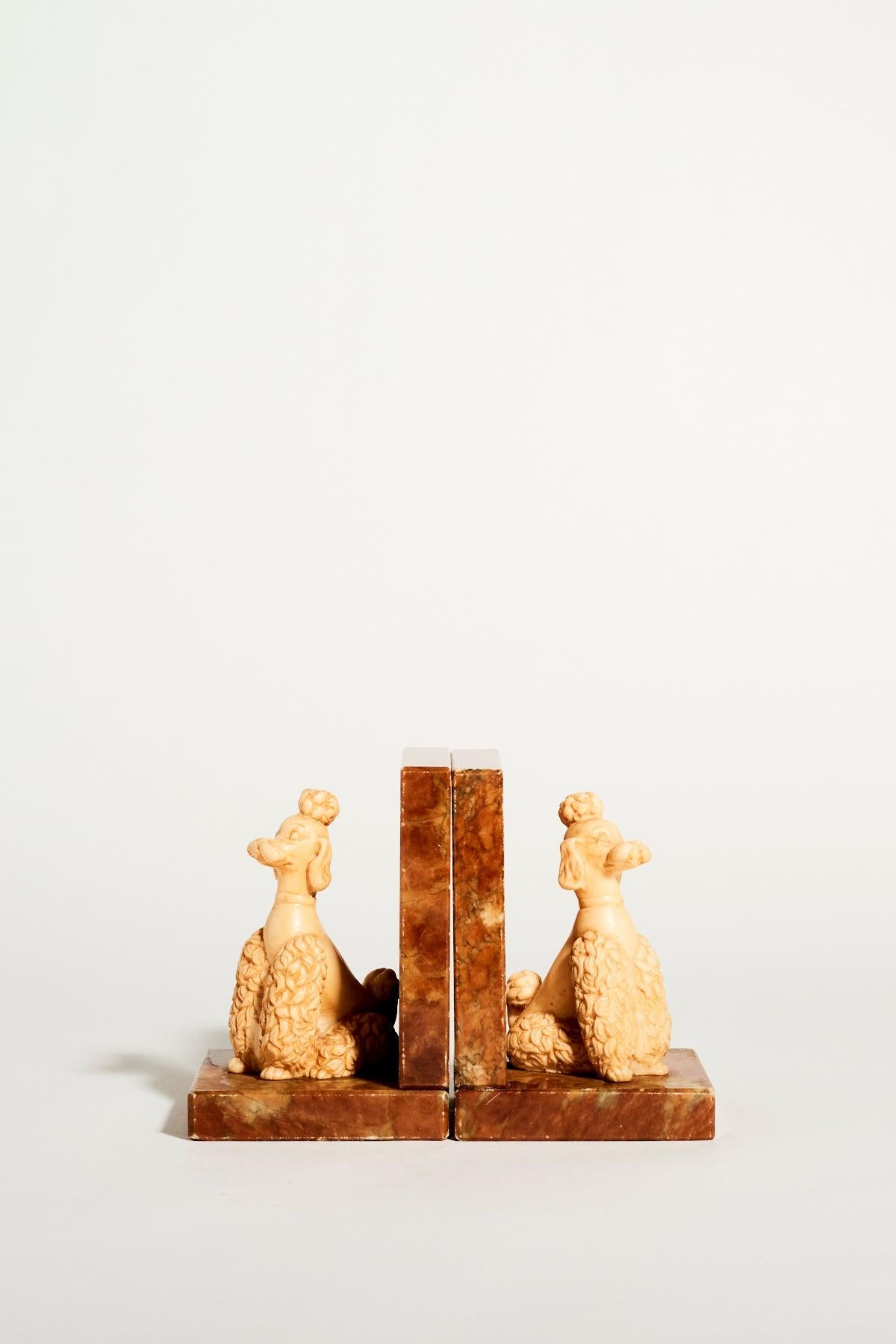 Italian alabaster bookends with regal poodles in cream and earthy color tones, marked made in Italy on base.
 