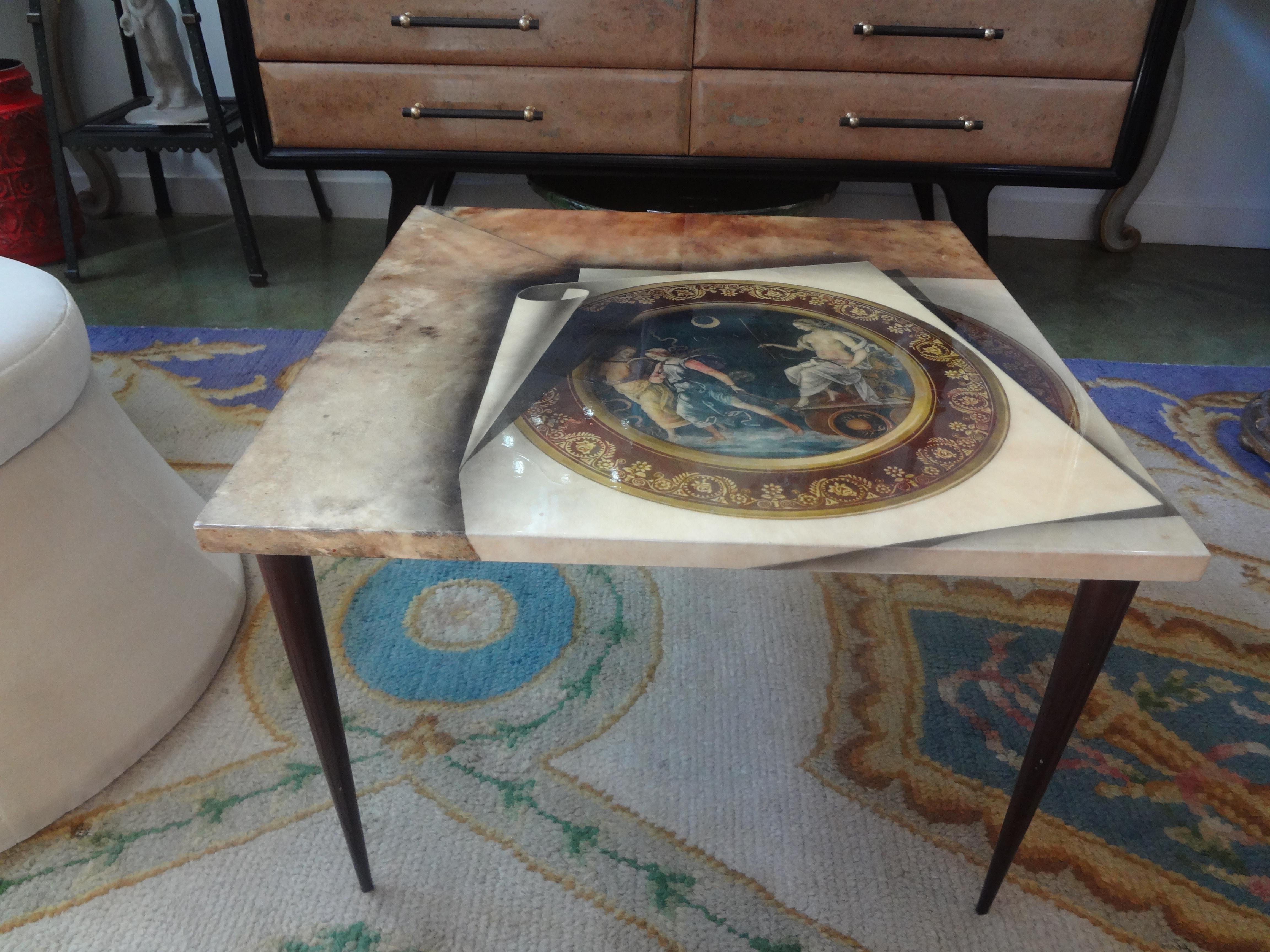 Italian Aldo Tura lacquered goatskin table. This stunning Italian lacquered goatskin square table has an unusual Neoclassical Trompe L'oeil design resting on tapered legs.
This lovely Italian Hollywood Regency table can be used as a side table or