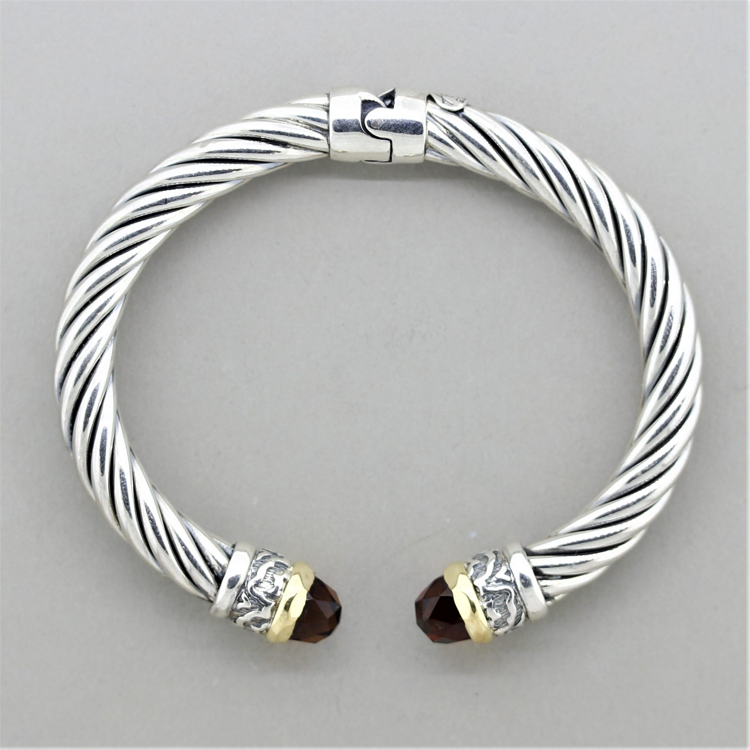 A classic example of Italian design, this bracelet by Alisa is made in both sterling silver and 18k yellow gold. It features 2 rose-cut garnets with a rich reddish-orange color. The twisted cable design is a classic Italian style.

Length: 8 inches
