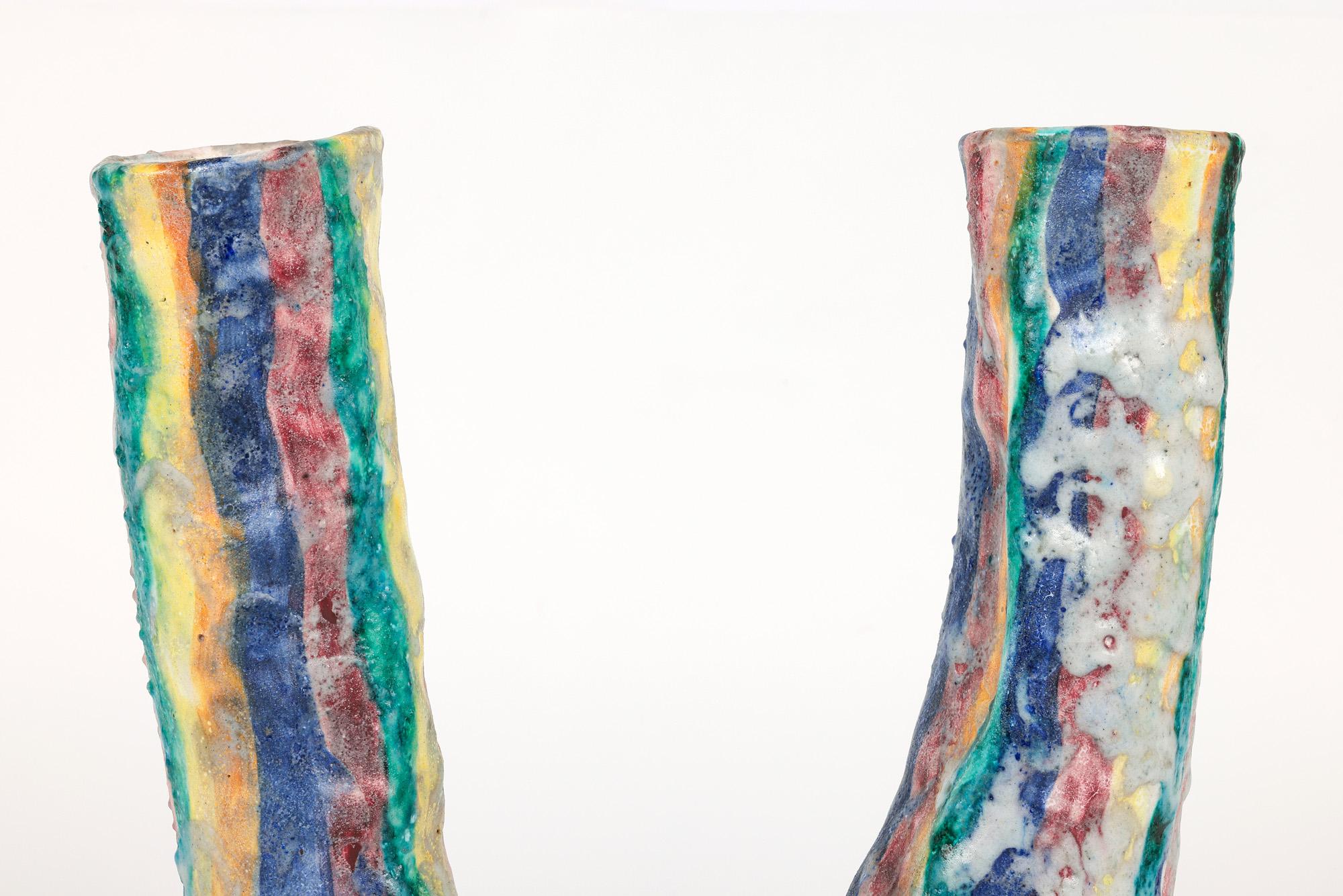 An unusual Italian mid-century twin spout art pottery vase in the manner of Guido Gambone with a roughcast finish signed GCC Amalfi and dating from around 1950. The hand-crafted vase stands on a narrow round unglazed foot with a U-shaped uneven
