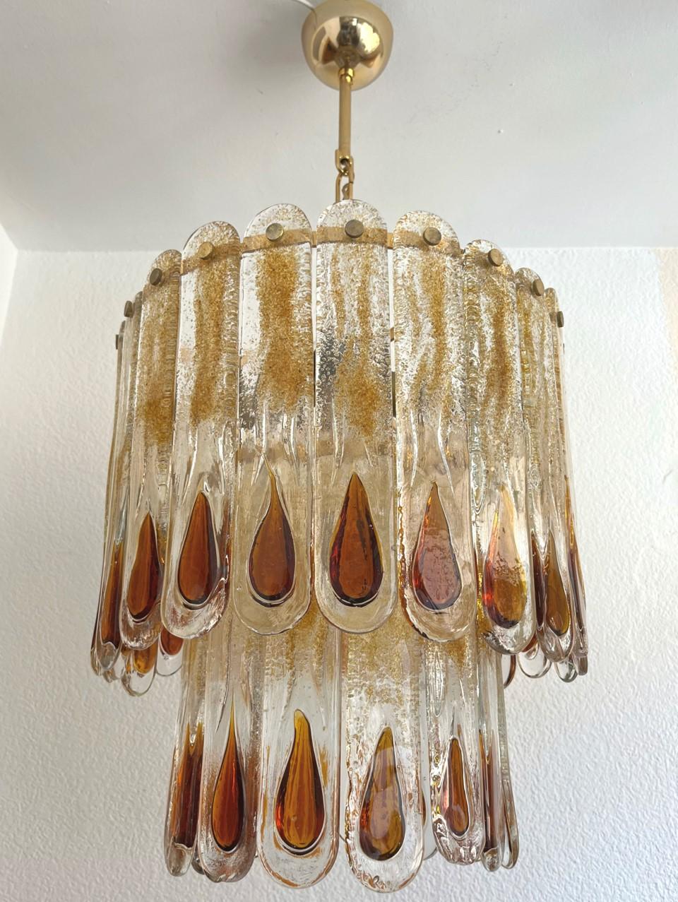 Marvelous and unique Italian amber Murano glass Chandelier from 1970s.
This fixture was made during the 1970s in Italy for the Venice Company “Mazzega”.
Mazzega lie in the noble Venetian glassworking tradition; the firm was founded Angelo Vittorio