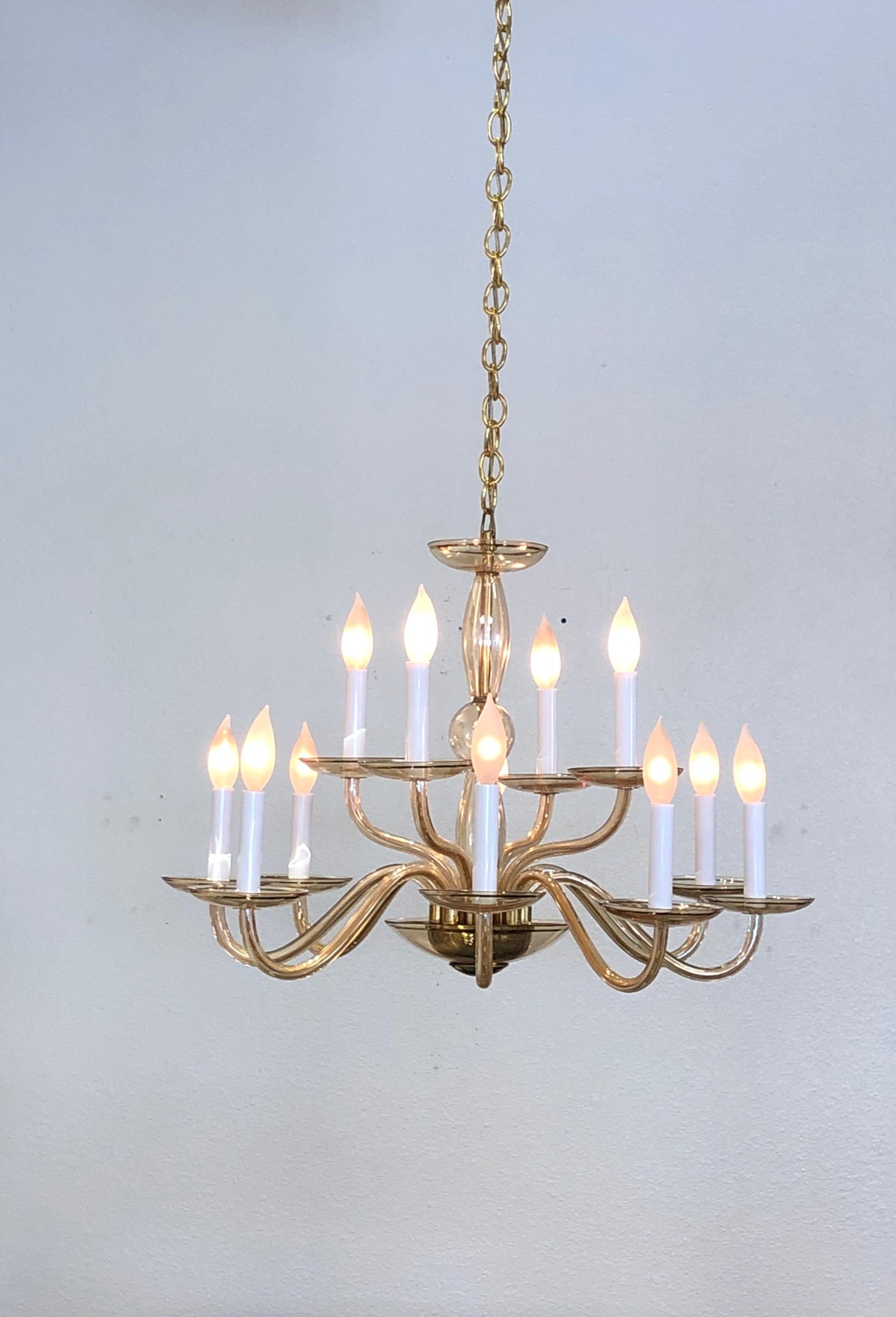 Italian Twelve-Arm amber Murano Glass and brass chandelier from the 1970’s.
Newly rewired. We can extend the chain to any length. 
Measurements: 27” Diameter and 20” High without chain.