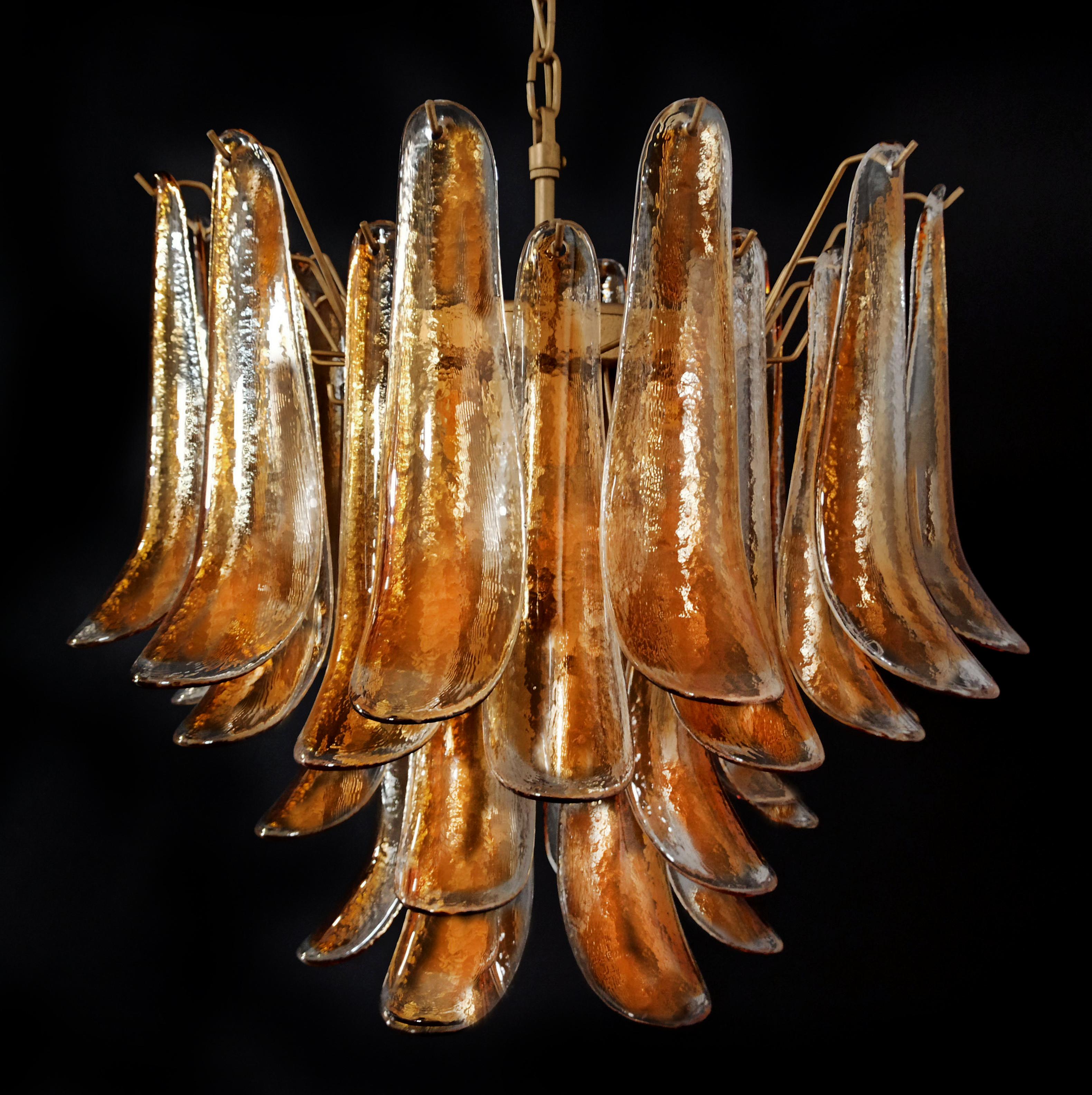 Chandelier with 36 transparent with an amber spot inside glasses, gold painted structure. The glasses are very high quality, the photos do not do the beauty, luster of these glasses.
Period:late XX century
Dimensions:47,25 inches (120 cm) height