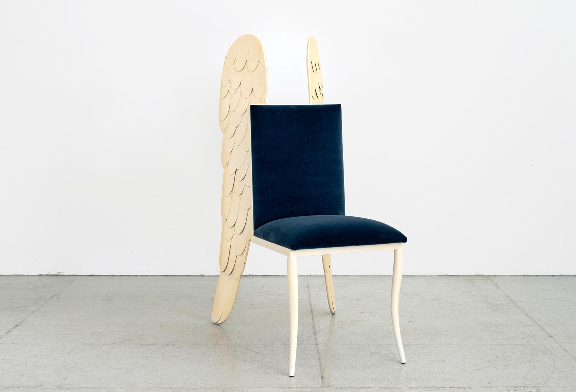 1980s Italian sculpture chair with carved angel wings and floating seat.
Enameled metal intricately designed - wings serve as the back 2 legs of the chair. 
Original finish with newly upholstered blue mohair seat.

Great piece for a corner in