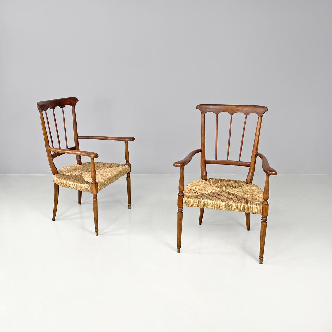 Italian mid-century modern armchairs wood and straw with two brass feet, 1950s
Pair of armchairs in wood and straw. The backrest has a decorated wooden band at the top to which three wooden slats are connected. The armrests have rounded curved
