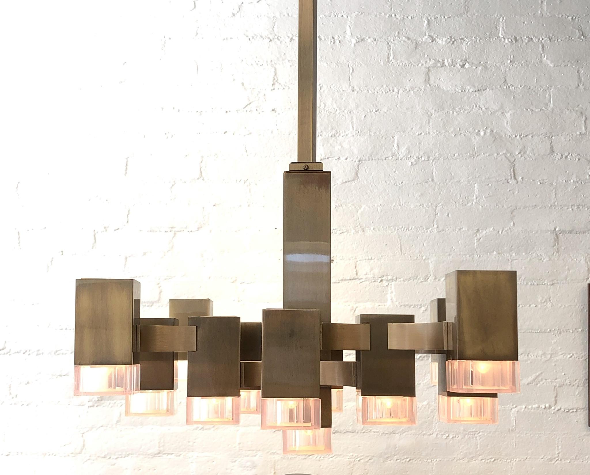 A spectacular cubic chandelier designed in the 1970s by Italian designer Gaetano Sciolari for Lightolier. The chandelier has a beautiful antique brass finish and acrylic light covers. The chandelier retains the Made in Italy and Lightolier labels on