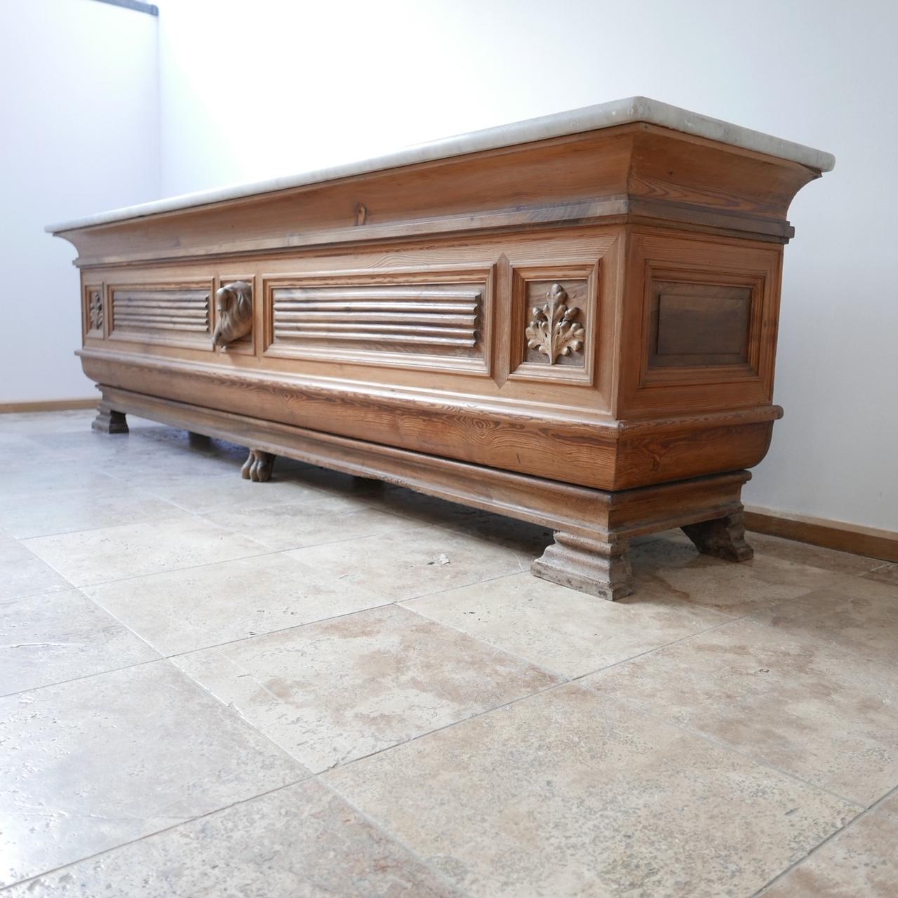An exceptional Italian charcuterie serving counter from the Parma region.

Long thick marble top.

The wooden front has leaf detailing, a carved pig to the centre and even a carved trotter to the base.

The back side is functional meaning it