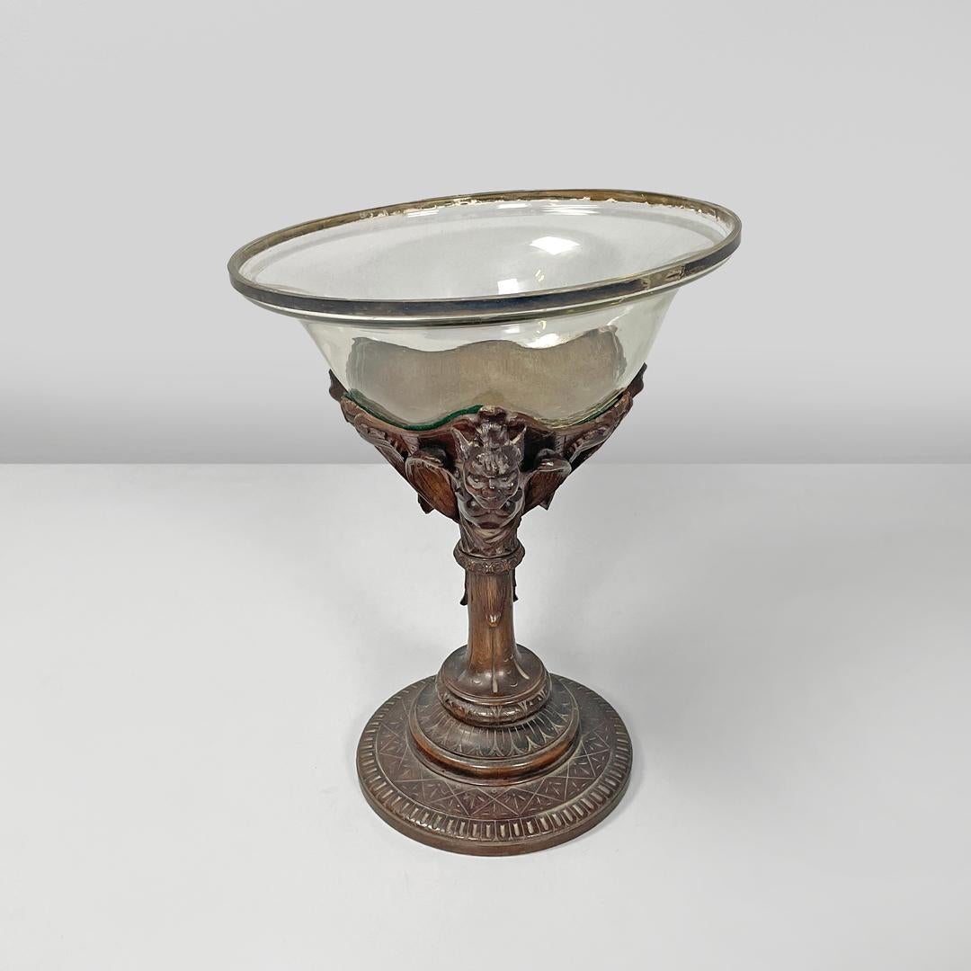 Italian antique cup with glass hemisphere and decorated wood stem, early 1900s
Wood and glass cup with a round base. The upper part is composed of a transparent glass hemisphere, inside there is a silver part that joins the glass to the structure.