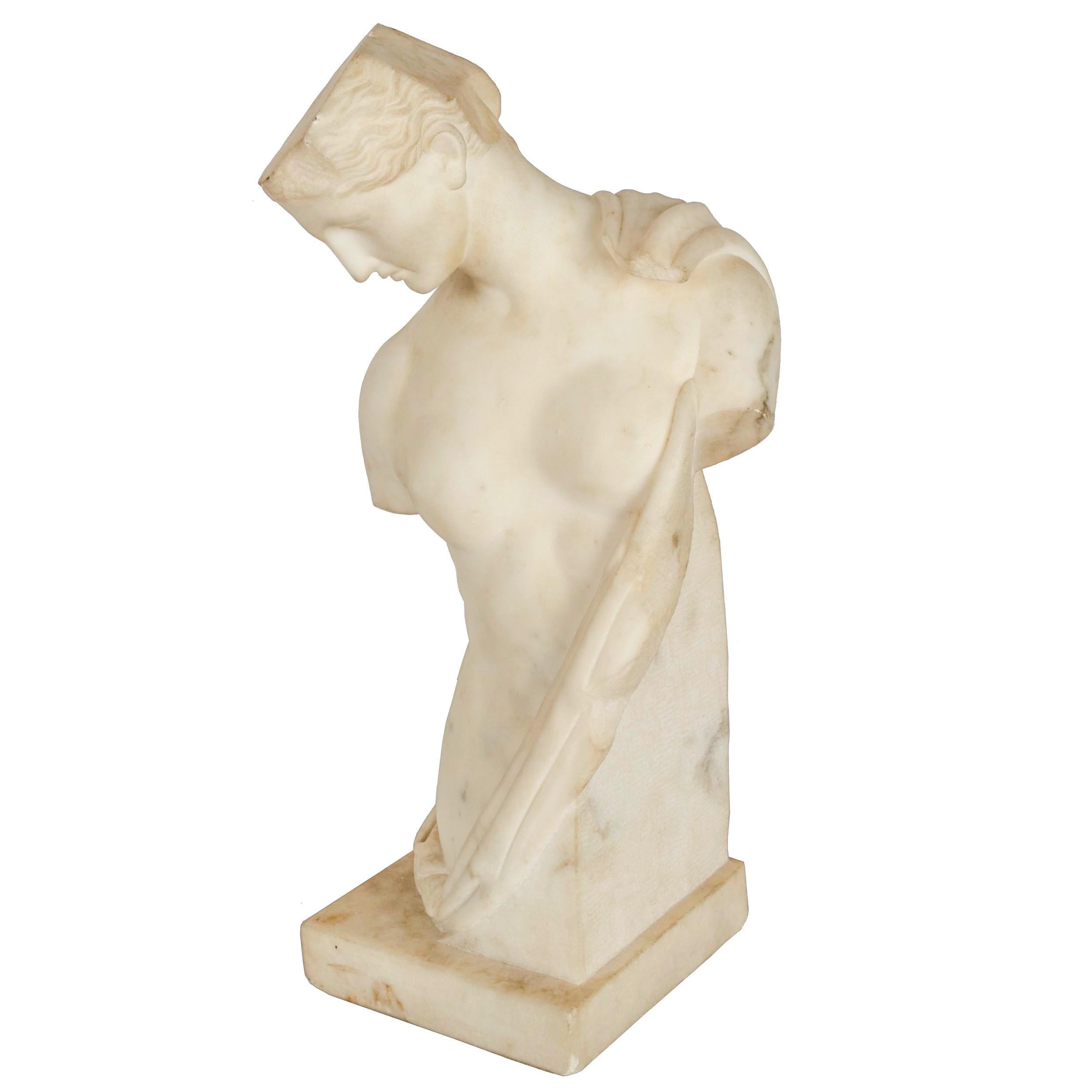 A finely chiseled marble sculpture of a goddess draped in a loose garb, it is a product of the Grand Tour and likely dates to the third quarter of the 19th century. The ancient sculpture that inspired this model was found in the amphitheater of
