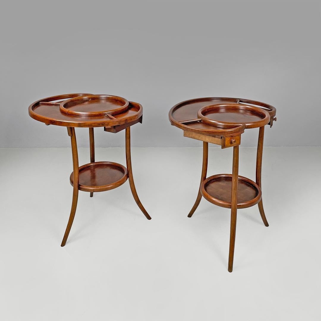 Italian antique rounded wooden coffee tables with two drawers, early 1900s
Pair of service tables or coffee tables entirely made of wood. The rounded top has rounded profiles that delimit an internal circular space and an edge, on the sides there