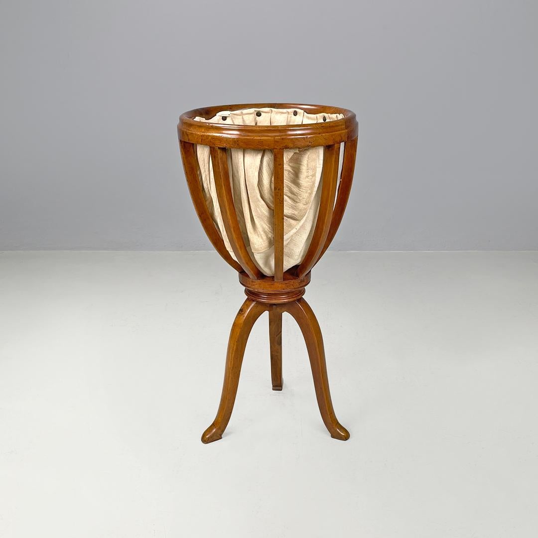 Italian antique sewing stand with wood basket and fabric lining, 1800s
Wooden and cotton yarn stand or sewing stand. The upper part is composed of a basket with a round edge and rounded arms, which contains a raw-woven ivory-white cotton lining,