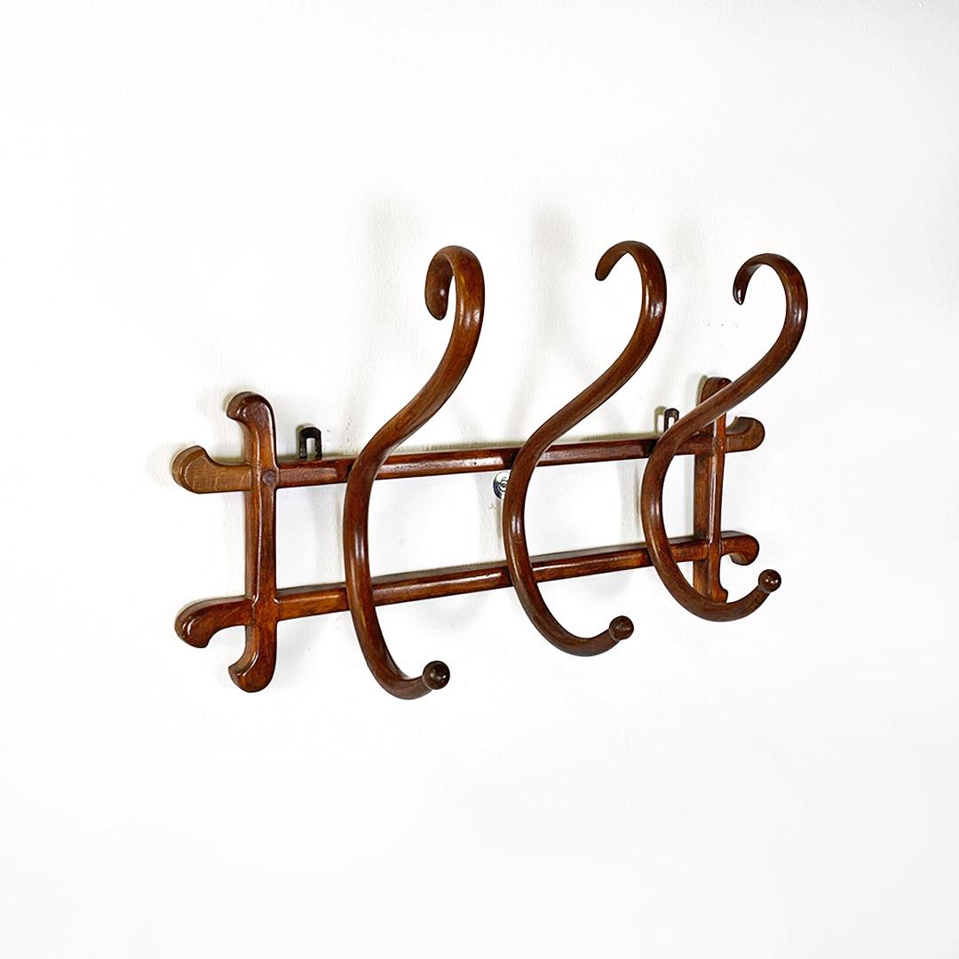 Italian antique solid beech wood hanger coat by Thonet, 1900s
Shaped solid beech wood hanger with dark colour, with two rear metal hooks. Provided with a total of three points of use, with each single hanger composed of a 