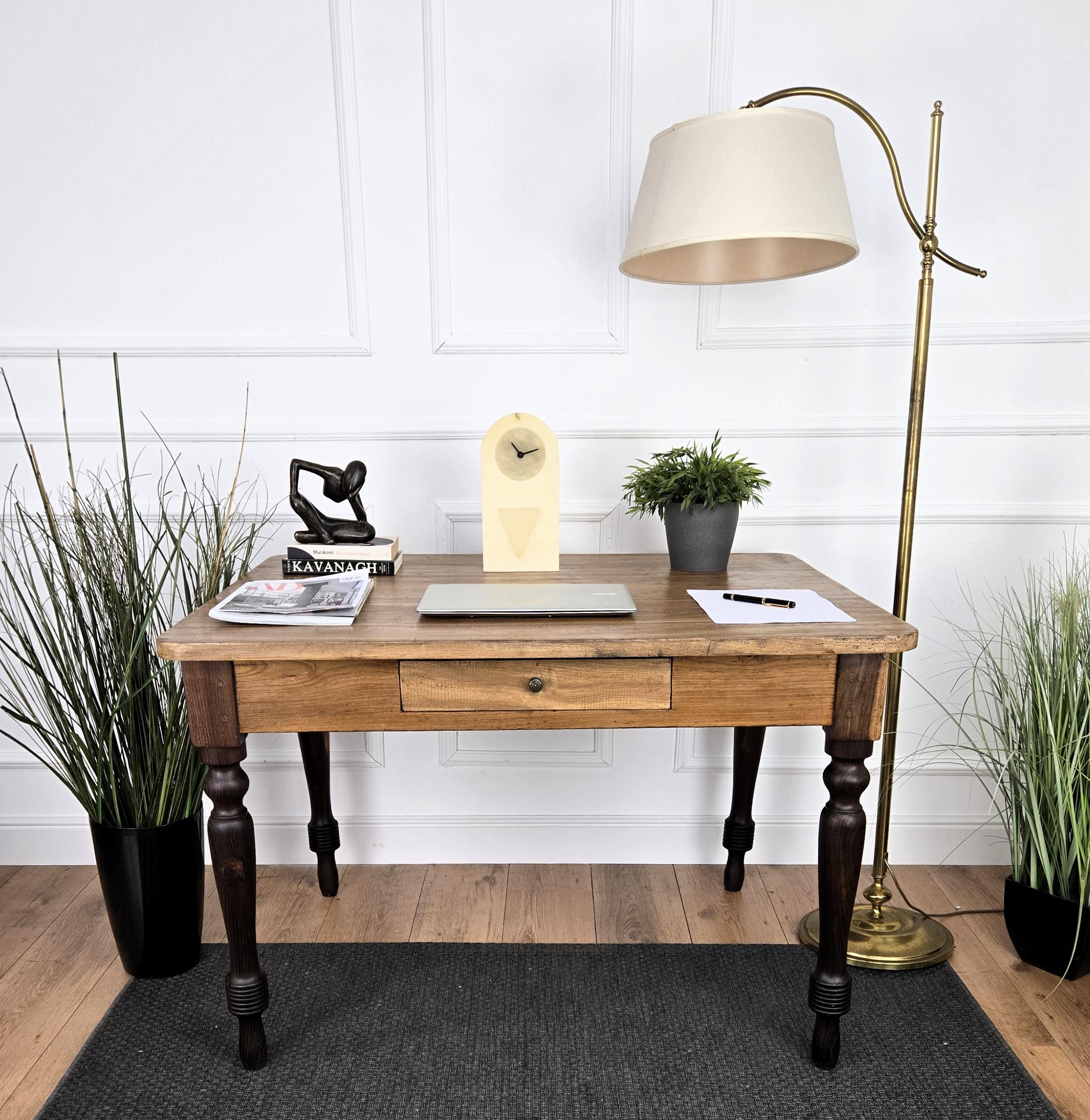 Very charming and elegant Italian antique dining table or desk writing table in solid walnut wood with double wood coloring, lighter for the top and darker on the stylish carved legs completed with a typical central drawer. Ideal in any interior to