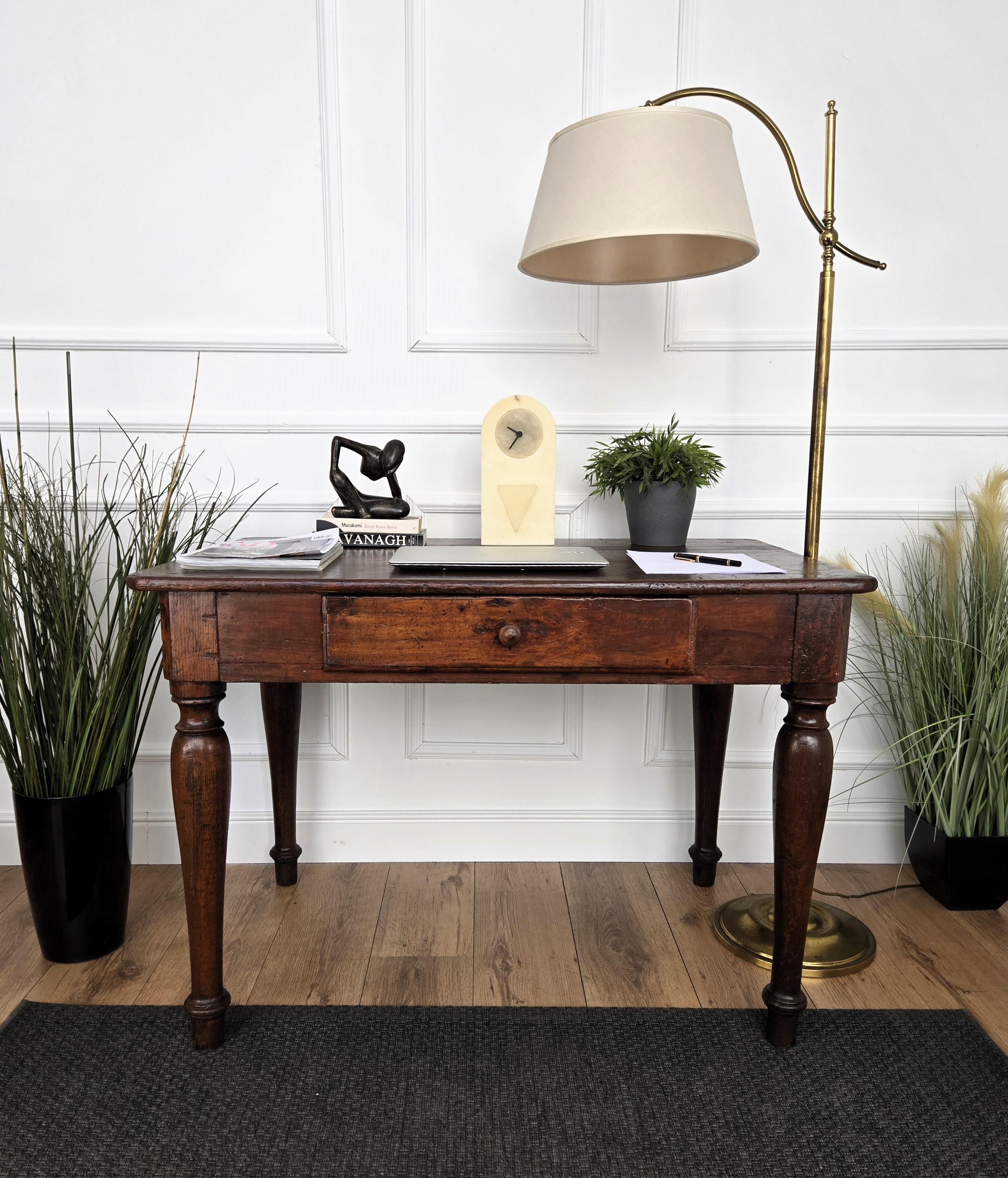 Very charming and elegant Italian antique dining table or desk writing table in solid walnut wood with stylish carved legs and central drawer. Ideal in any room as a small stand alone corner desk as well as next to the wall.
