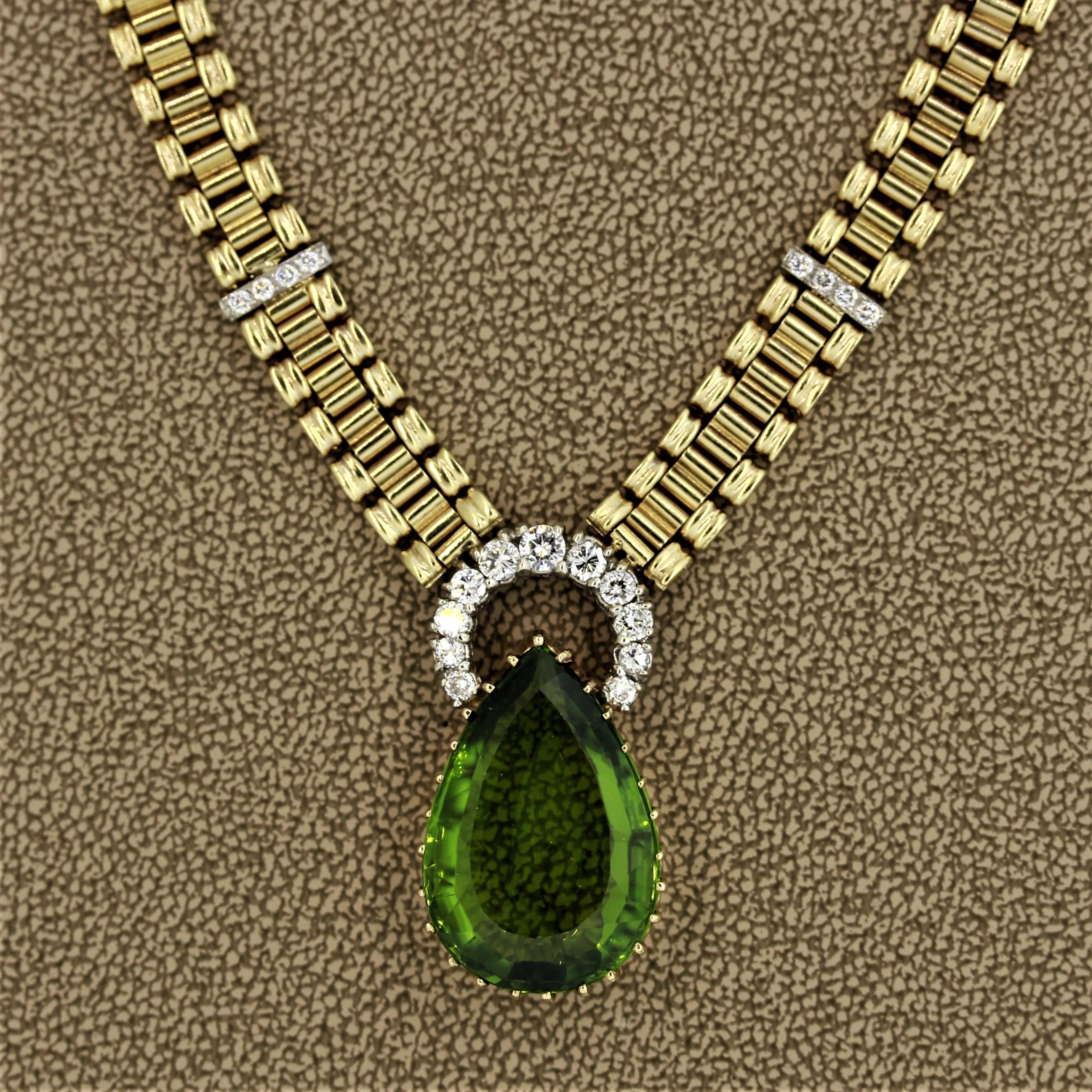 Here we have an expertly made necklace featuring a large pear shaped peridot weighing 16.45 carats. It is set in classic Victorian-era multi claw prong style. It is accented by 0.65 carats of round brilliant cut diamonds set in 14k gold. Made in