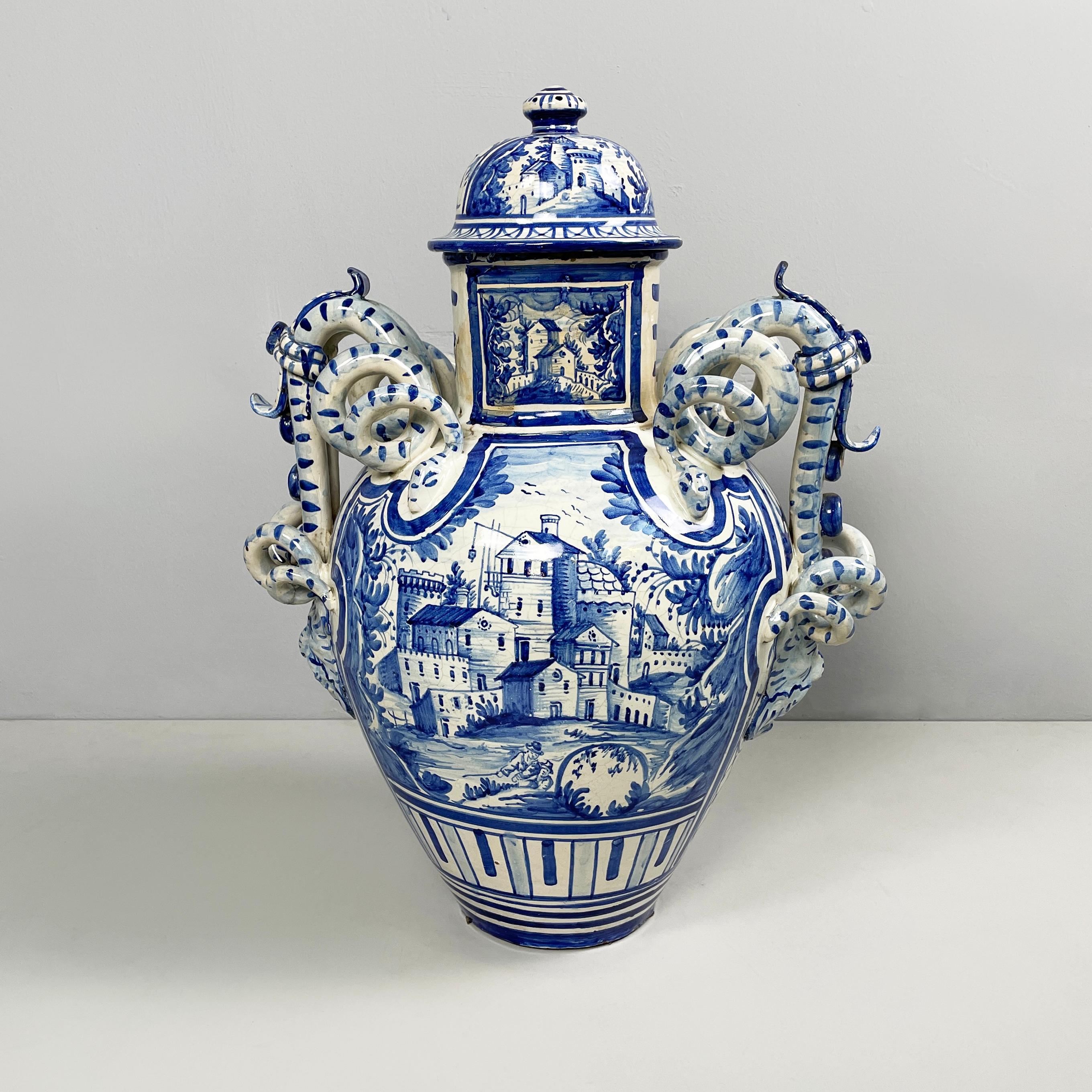 Italian antique vase with lid in blue and white majolica, 1715
Vase with lid with round base in blue and white majolica. On one side of the vase there is a landscape. The handles are snake-shaped with decorative faces on the lower part.
It came from