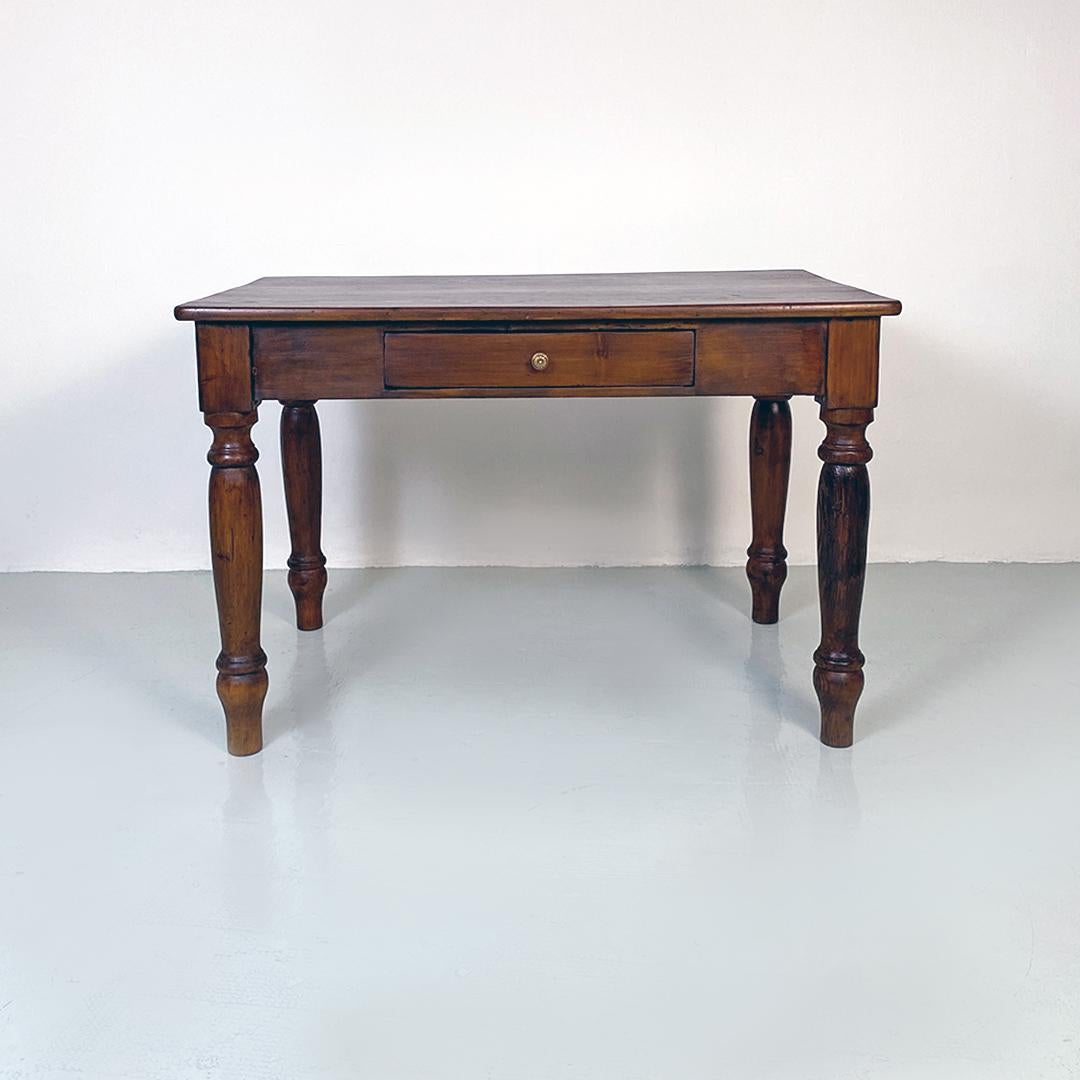 Italian antique walnut dining table, 1900s
Rustic table with structure entirely in walnut with rectangular top, four turned legs and drawer on the front with burnished brass detail.
Perfect for a kitchen or a dining room, both with an antique