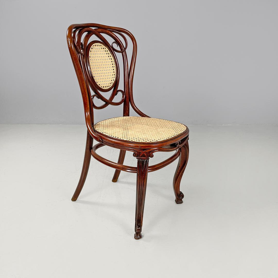 Italian antique wood and Vienna straw chairs with curl details, early 1900s
Set of four chairs in wood and Vienna straw. The wooden structure has cylindrical and rounded profiles, and forms curled decorations on the backrest and legs. The seat and