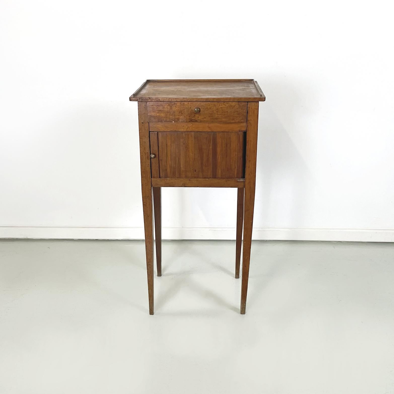 Italian antique Wooden bedside table with brass handle, early 1900s
Bedside table or service table with rectangular top, entirely in solid wood. On the front it has a drawer and a compartment with a sliding door. Round base handles in brass. Square