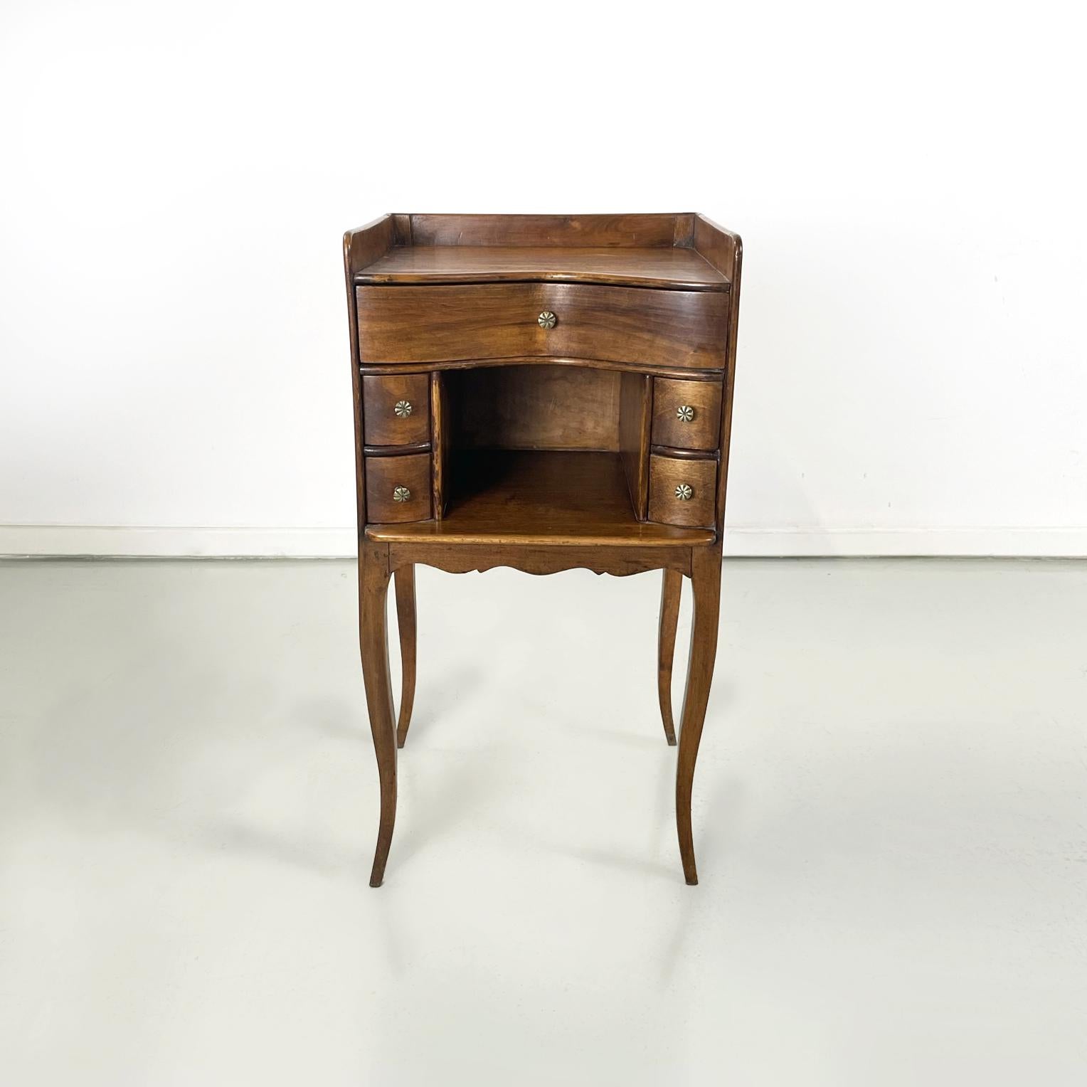 Italian antique Wooden bedside table with brass handle, early 1900s
Bedside table or service table with shaped top, entirely in solid wood. On the front it has a drawer in the upper part and an open compartment with two small drawers on each side.
