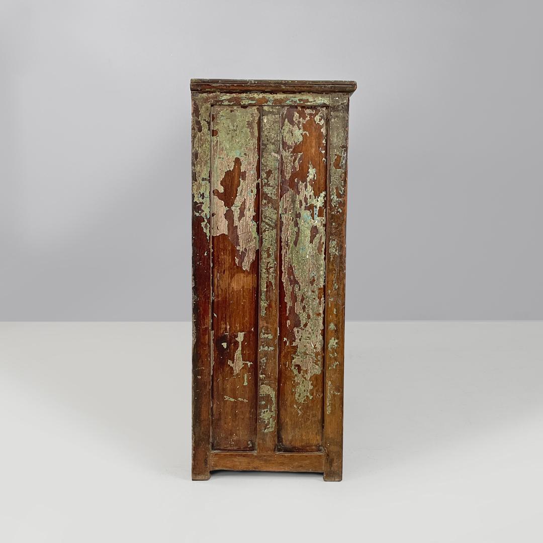 Italian antique wooden cupboard with glass doors and brass handles, early 1900s
Wooden cupboard or kitchen cabinet with a rectangular base. It has two glass doors divided into four panels, with two rounded brass handles, a lock and a block, all in