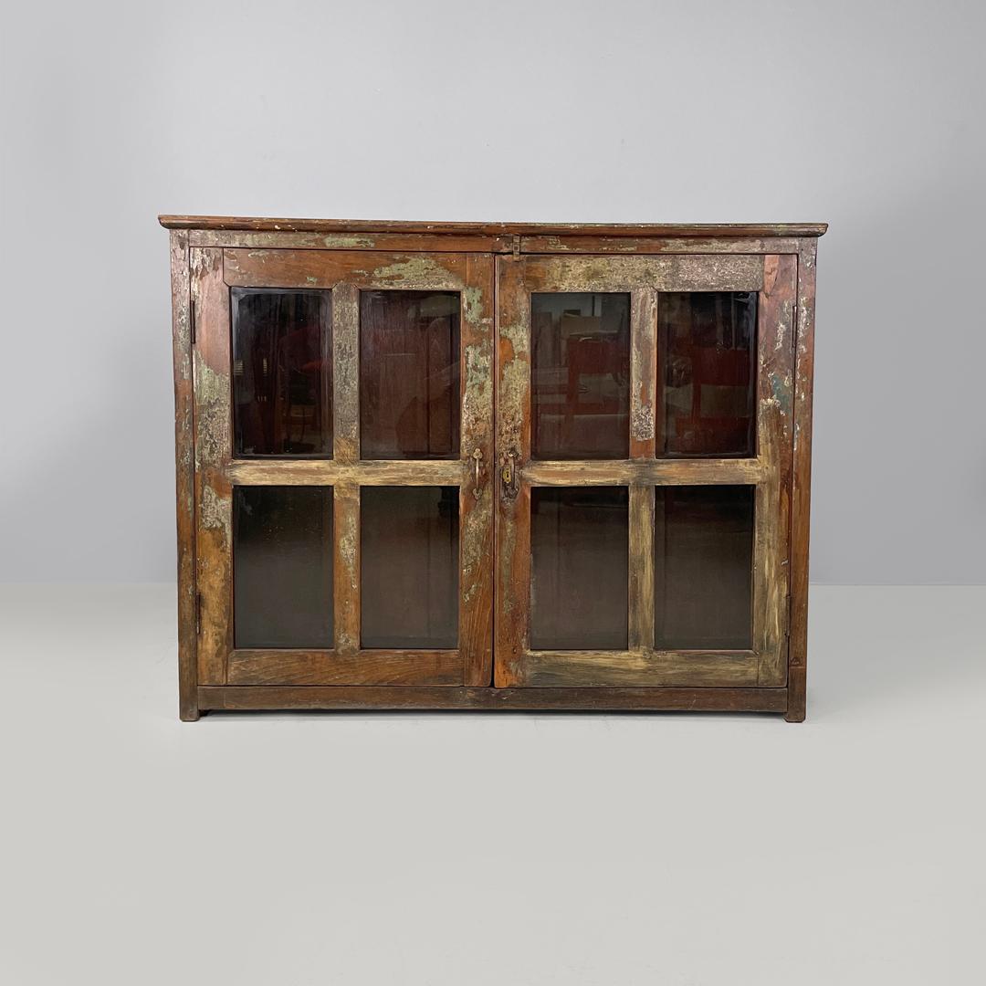 Italian antique wooden cupboard with glass doors and brass handles, early 1900s In Fair Condition In MIlano, IT
