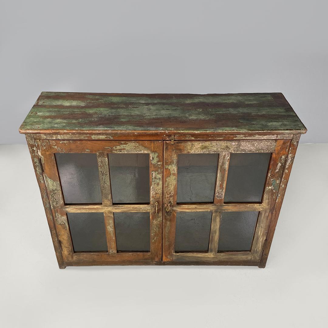 Early 20th Century Italian antique wooden cupboard with glass doors and brass handles, early 1900s