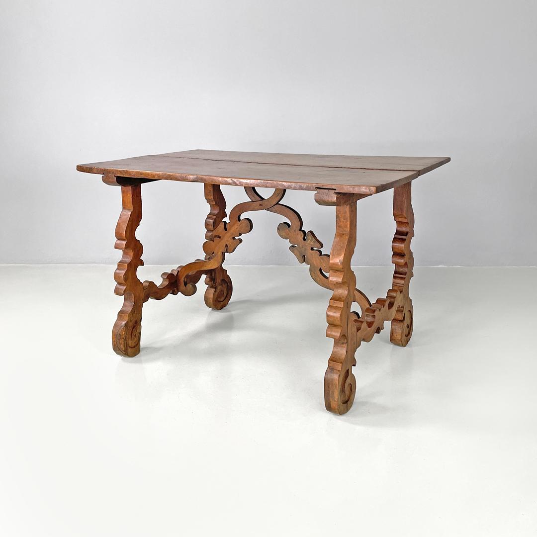 Italian antique wooden fratino table with decorated legs, 1700s
Refectory fratino table with rectangular top. It has four legs and two richly decorated and shaped diagonal central beams, with curved and rounded lines that recall the natural world.