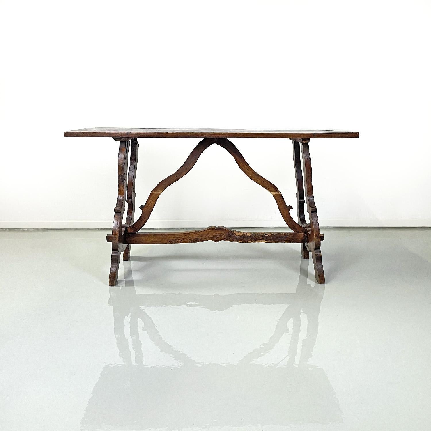 Italian antique wooden table with lyre legs, 1800s 
Entirely wooden dining table with rectangular top and lyre legs. In the center of the legs there is a decorated beam that structures the base of the table together with two other shaped components