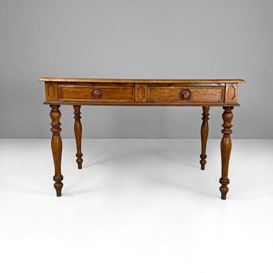 Italian antique wooden table with two drawers and turned legs, 1800s
Dining table with rectangular top made entirely of wood. With two drawers with round wooden knobs, it has decorations on the sides and front. With four turned legs and round