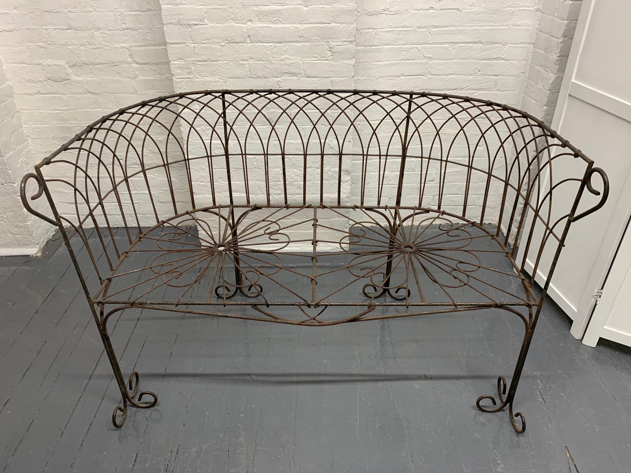 Lovely antique wrought iron bench with a beautiful pattern throughout the body.
