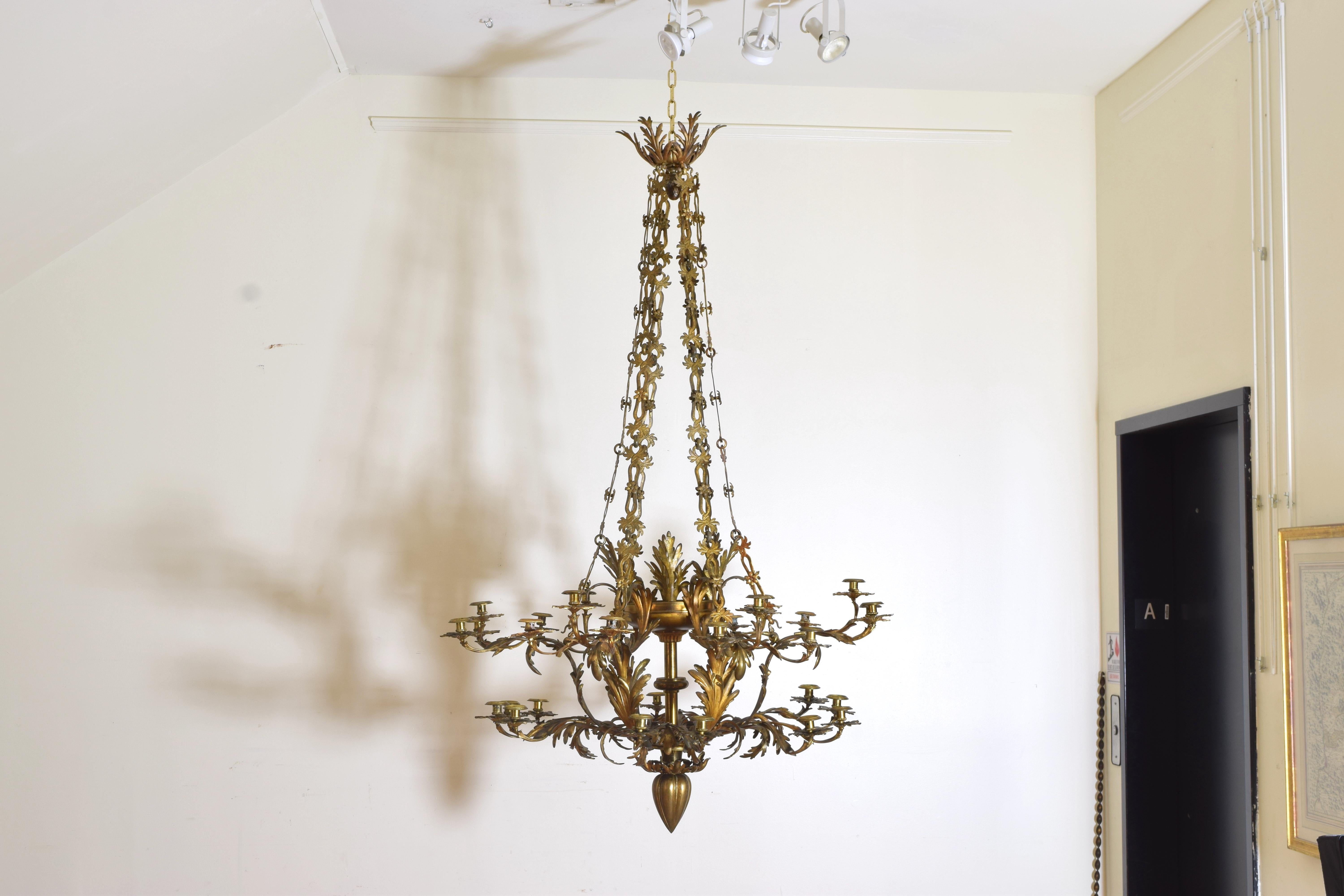 The chandelier is very likely from the boot of Italy, Lecce, which is also known as the Florence of the south. It has 30 lights on two different levels varying between two and three arms and an intricately detailed chain that leads from the body to
