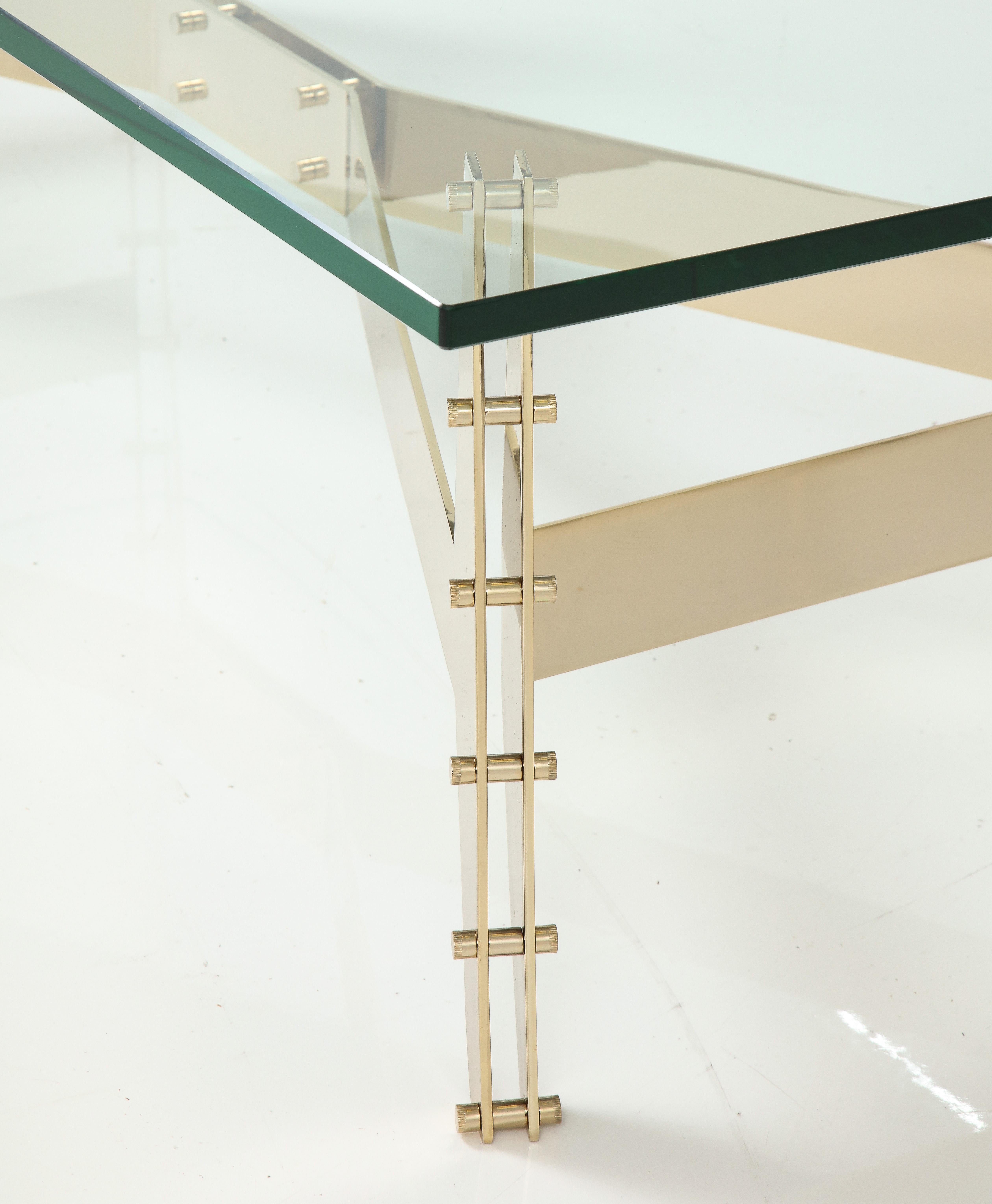 Beautiful architectural steel brass plated base with 3/4'' inch thick polished glass top coffee table, made and designed in Italy in 2016 with minor wear and patina there is a tiny chip to the glass.