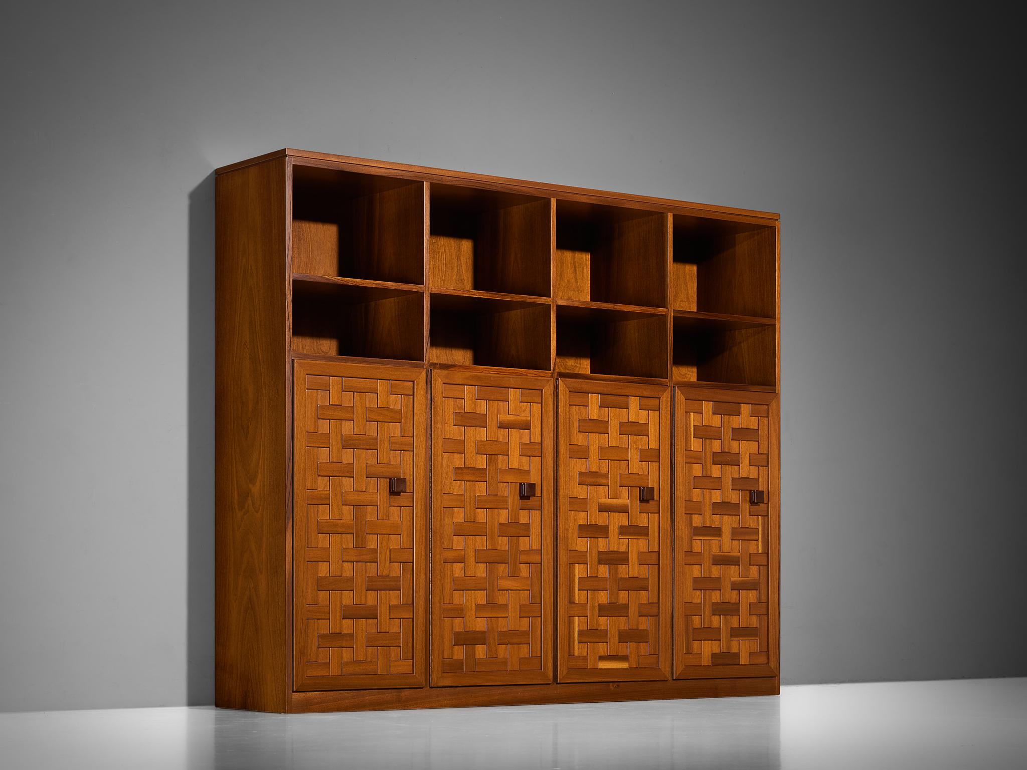 Highboard or bookcase, walnut, Italy, 1980s

Exceptional bookcase made in Italy that perfectly balances architectural elegance with a natural approach. The design is defined by a graphical structure, featuring a grid-like pattern of wooden