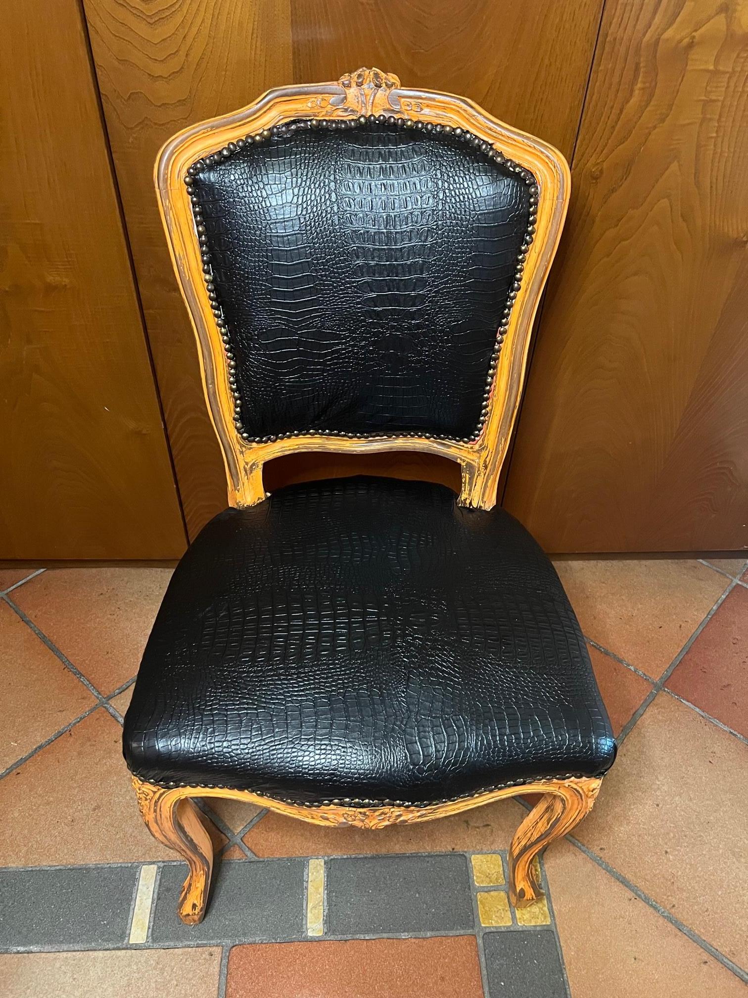 Italian armchair with covering in black faux crocodile imitation leather, structure in antiqued yellow / pink color beech.
 It is very elegant and comfortable.
Comes from an old shop in the Florence area of Tuscany.
As shown in the photographs