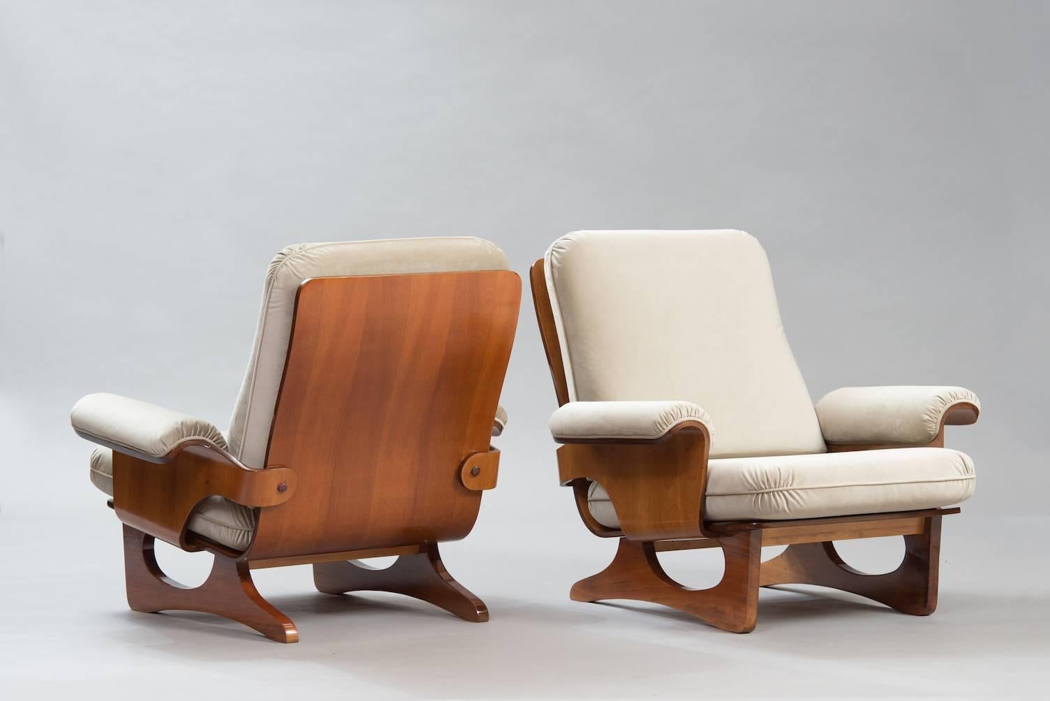 Pair of molded wood armchairs in walnut veneer reupholstered in warm grey velvet.