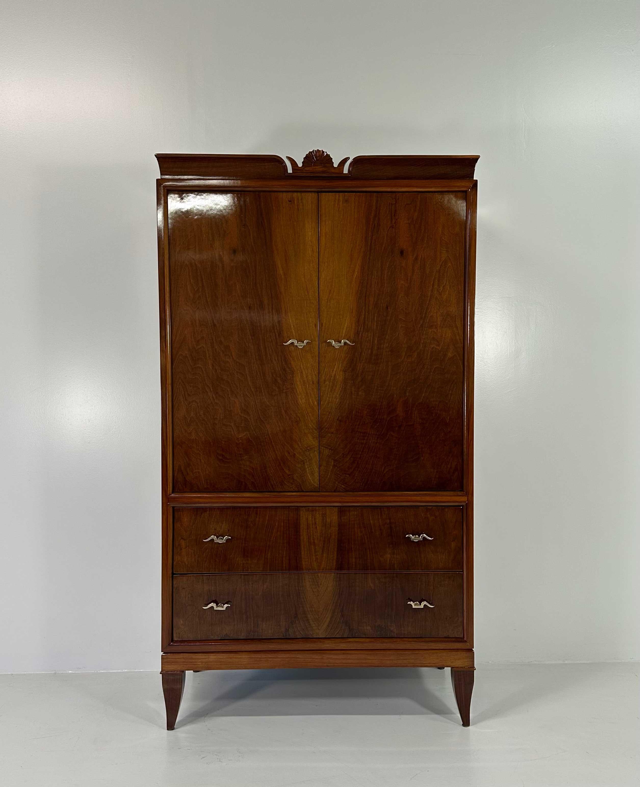 This wardrobe was produced in Italy, in Cantù (small village in the north of Italy, next to Milan), by Paolo Lietti & Figli and designed by Gio Ponti. It features a mirror manufactured by Luigi Brusotti and a matching dresser, as you can see in the
