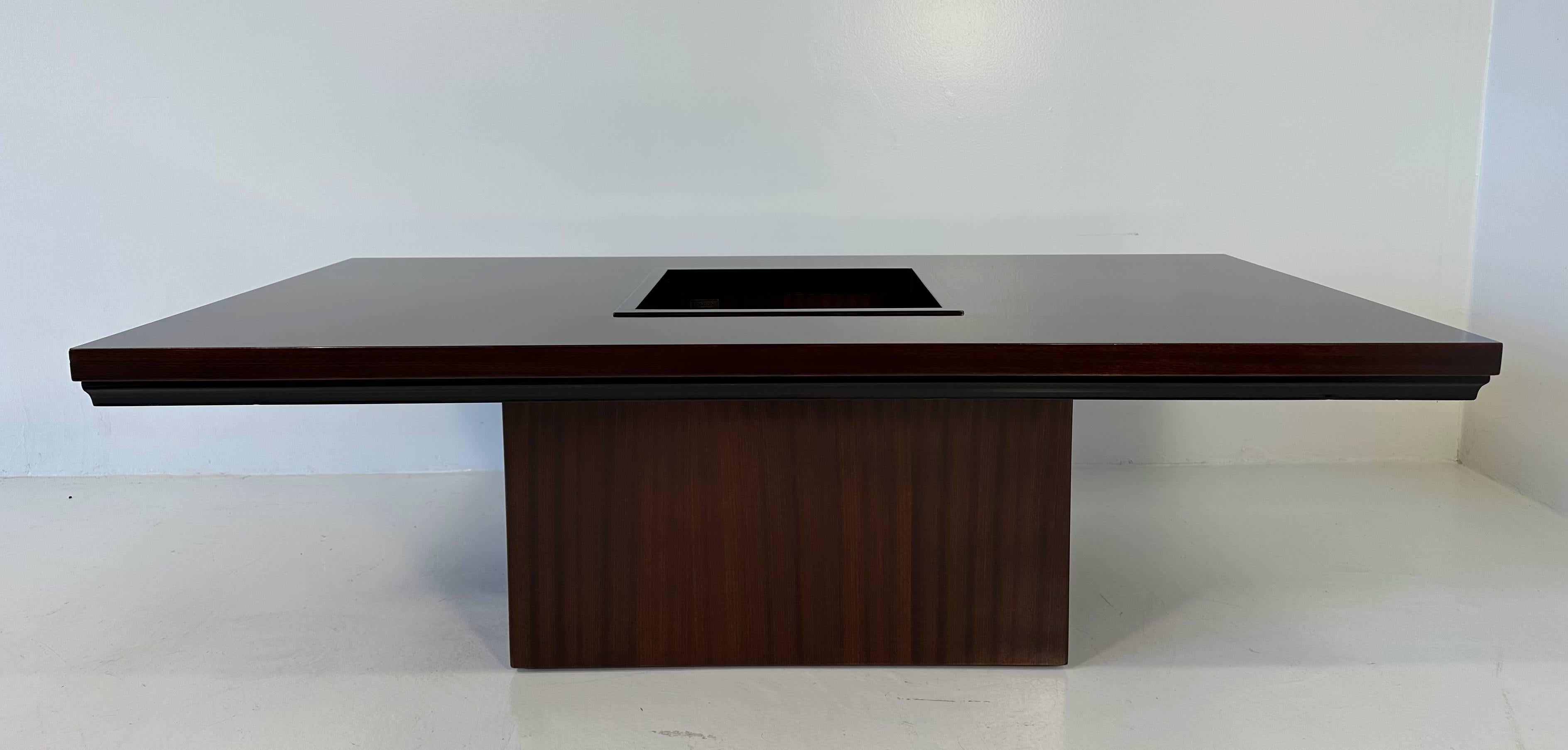 This Art Deco style Bar Table was produced in Italy in the 1980s by Longoni (signed on a metal label). 
The table is completely made of Mahogany, the exceptions are the decorative lines on the top that are two ebonized wood inlays and the profiles