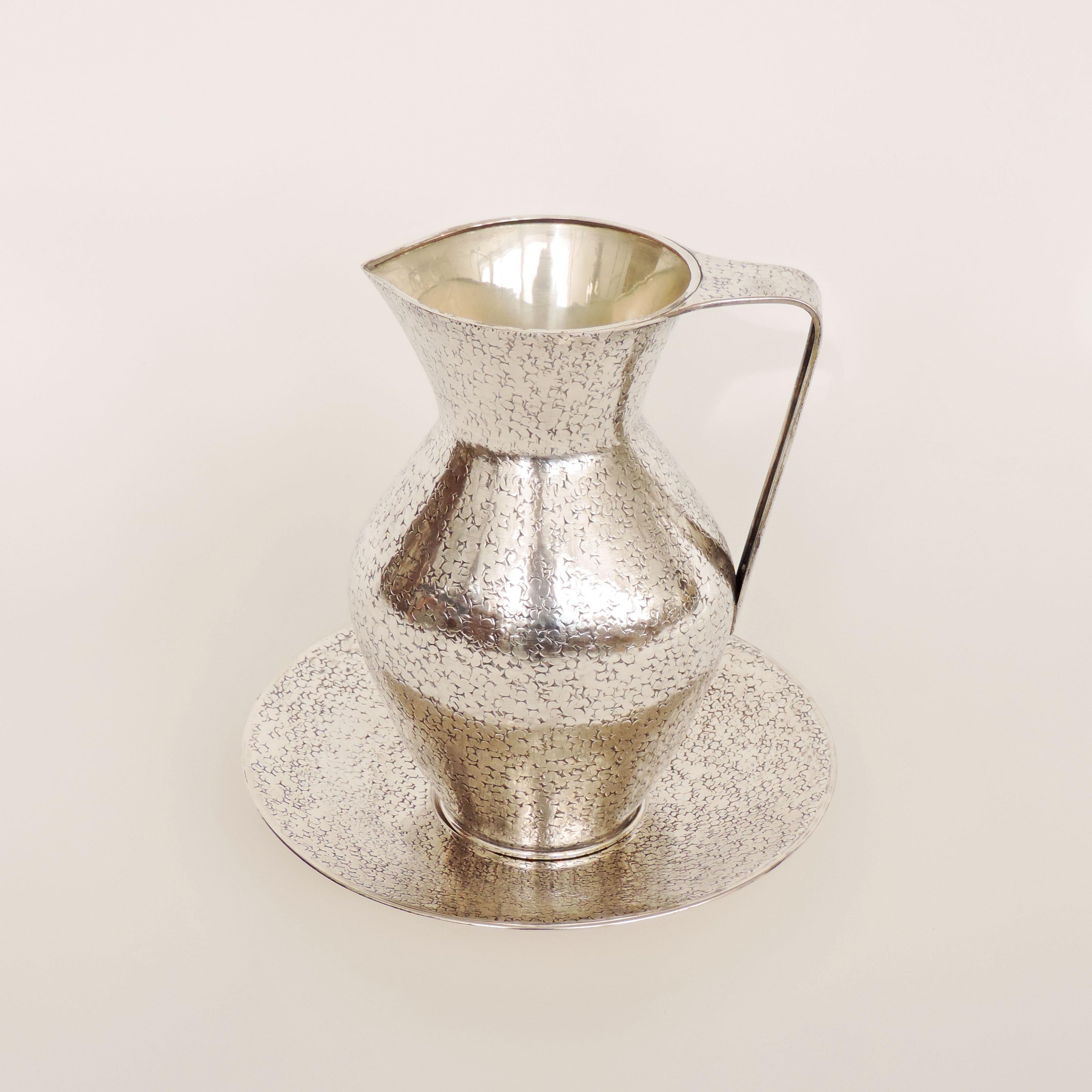 Italian 1940s silver jug and plate attibuted to Gio Ponti
Hallmark 800 a separate GP Hallmark and Unreadable Silver Hallmark
Plate measurement 25.5 x H 3cm.