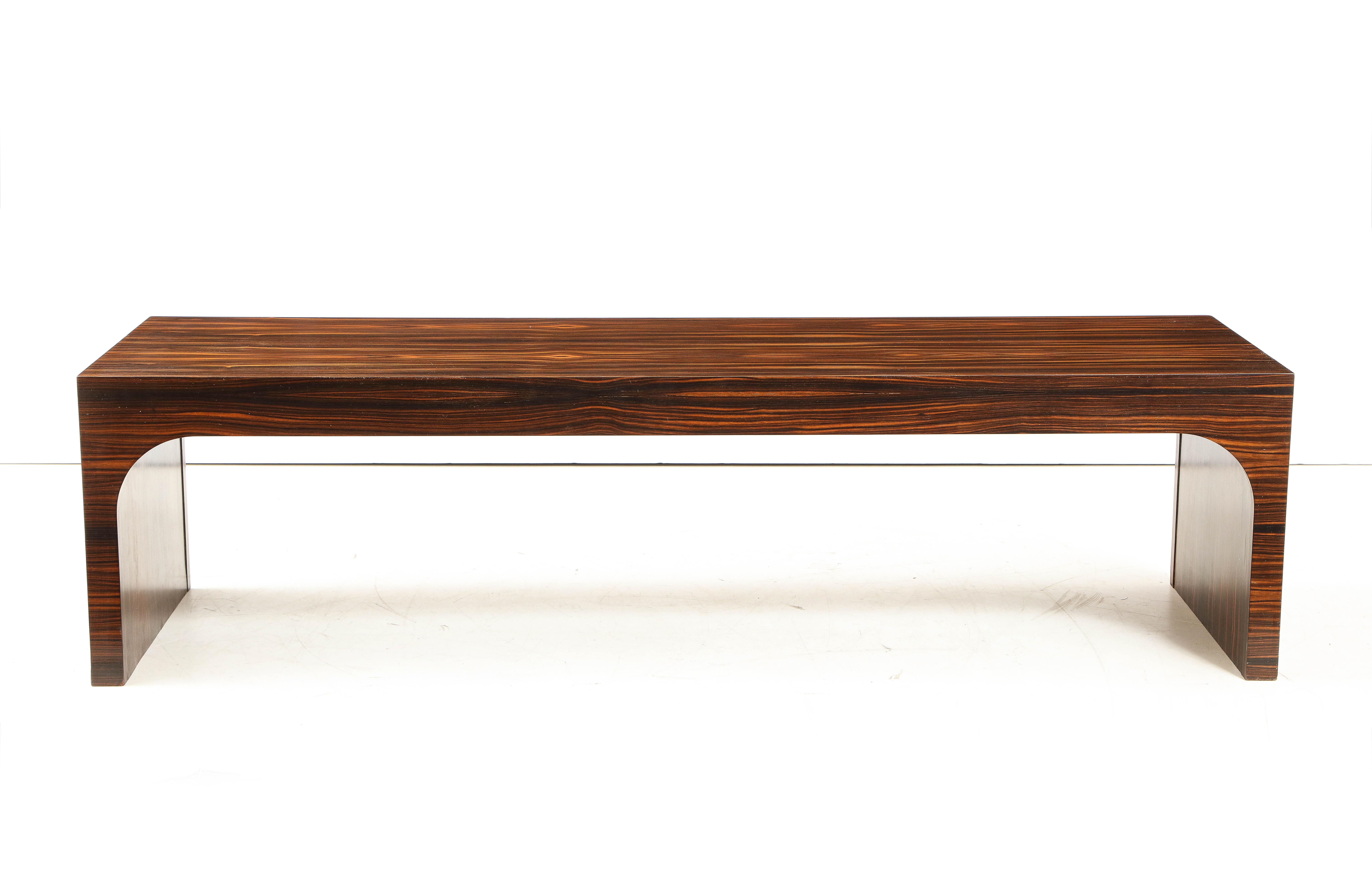Italian Art Deco Macassar ebony waterfall shaped coffee table or bench. This exotic and very elegant wood was popular in the Art Deco modernist period for its lushness and striking coloration and depth. A stunning and sleek piece.
Italy, circa