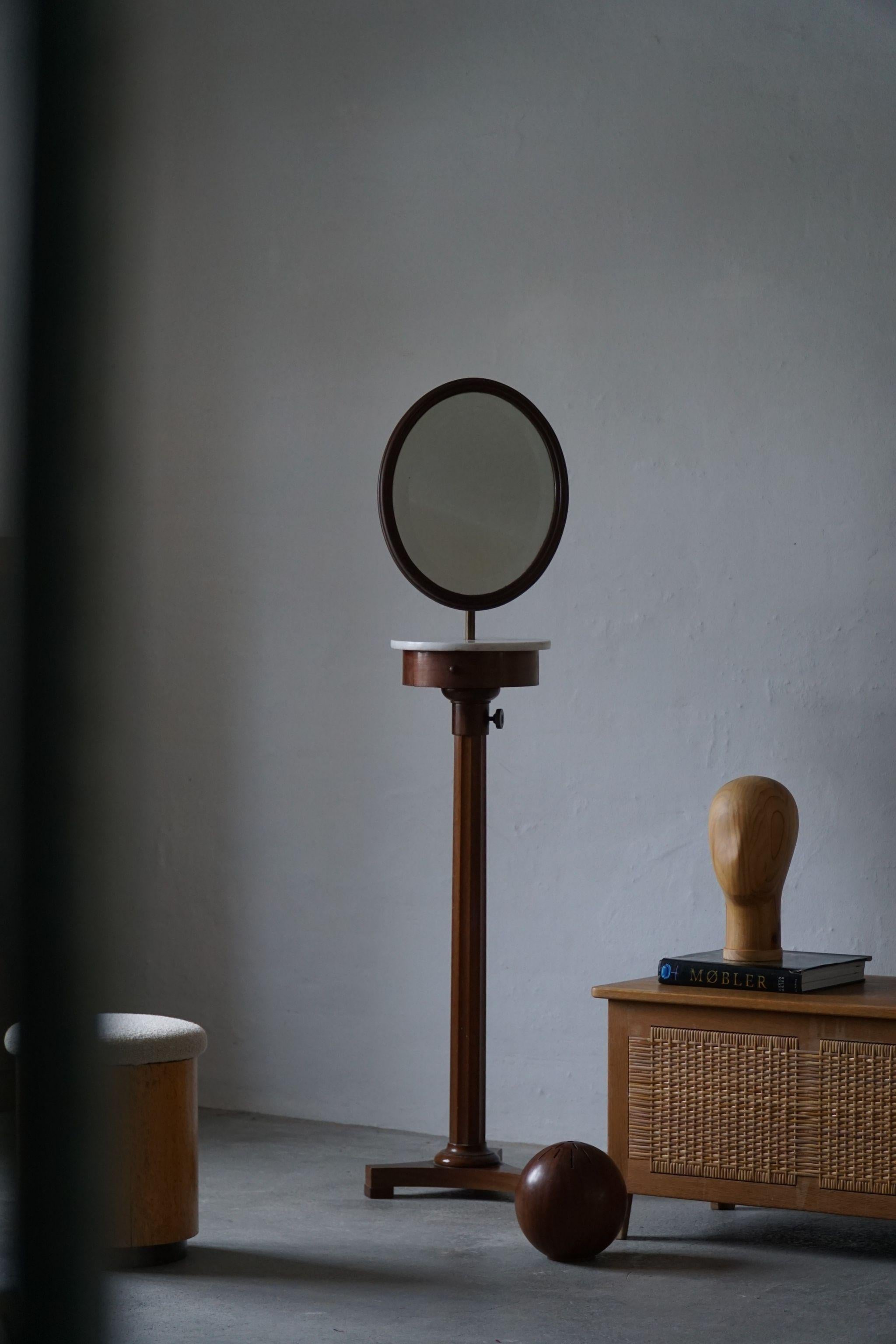A decadent freestanding Italian adjustable oval mirror. Made in walnut, with a marble top, underneath a small shelf. Such beautiful details and great craftmanship, made in the late Empire style. 

Measures: Full lenght 185 cm
Min. lenght 160 cm.