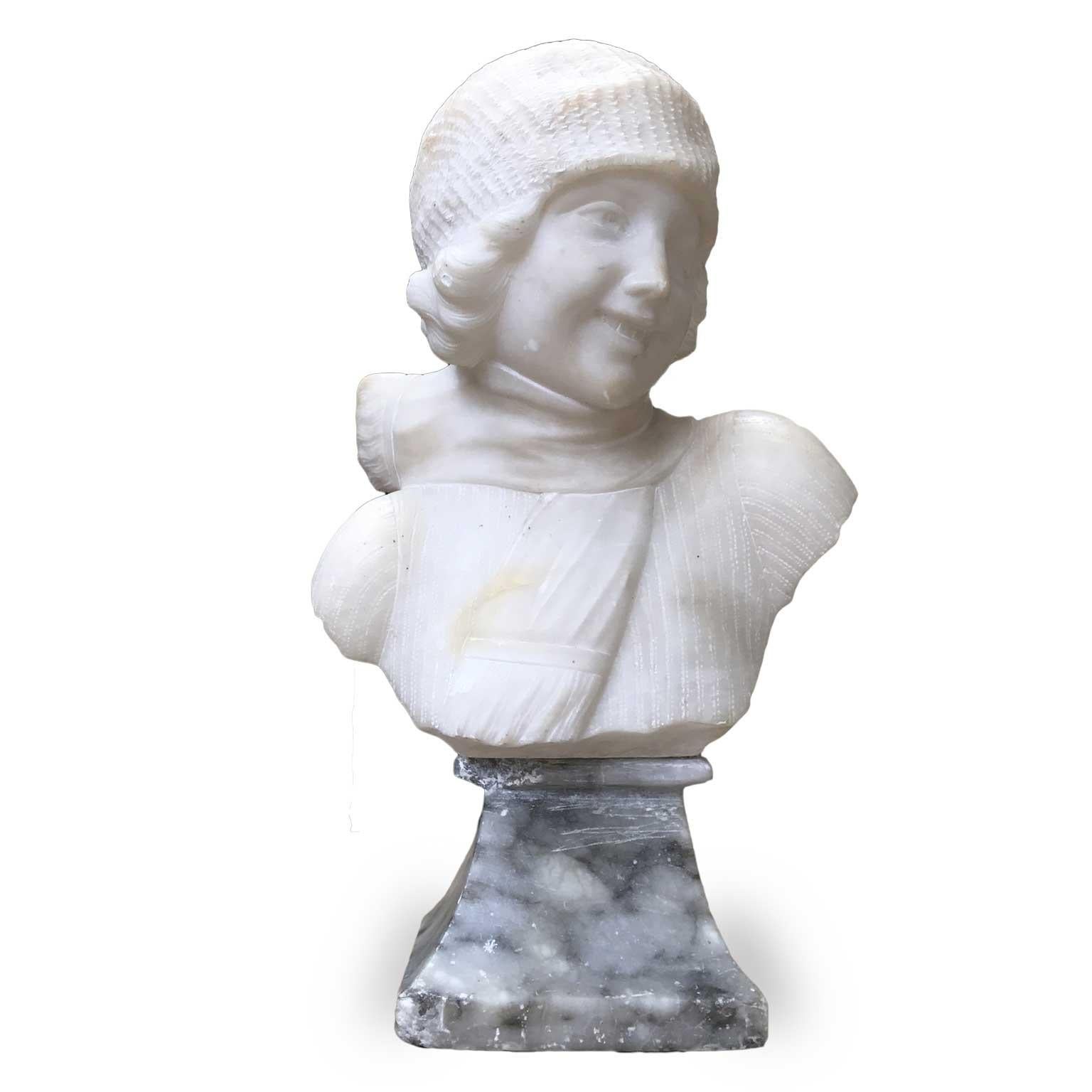 Art Deco alabaster female bust sculpture by O. Guerrieri, an early 20th century carved white alabaster half-bust of smiling girl wearing hat and scarf, signed on the back O.Guerrieri.
This antique sculpture stands on a shaped squared gray alabaster